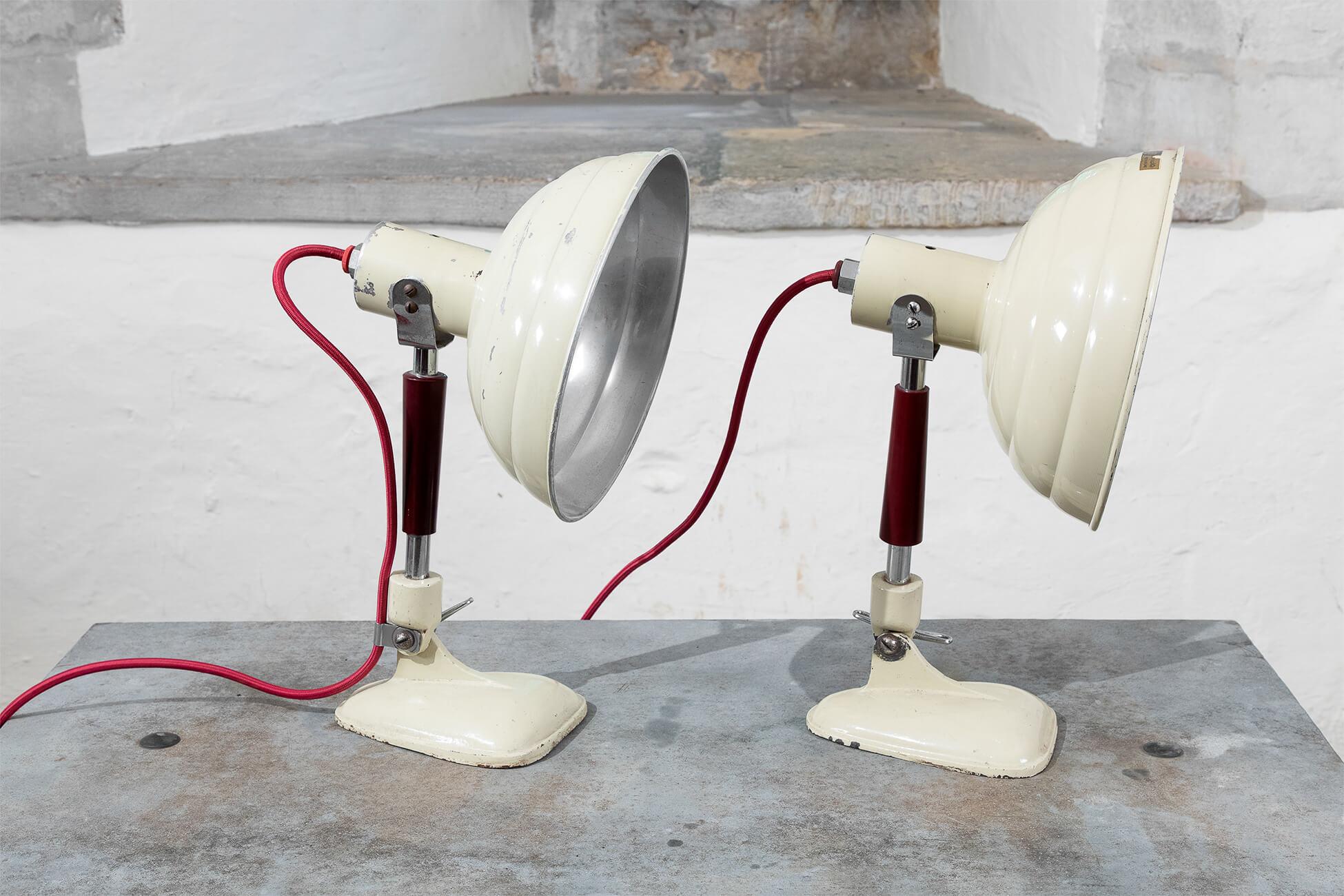 A pair of original Pifco heat lamps converted for use in the home or office. With a fabulous shape and great vintage character to their cast iron base and aluminum shade. Price is for the pair. The lamps can easily be used in both the USA and