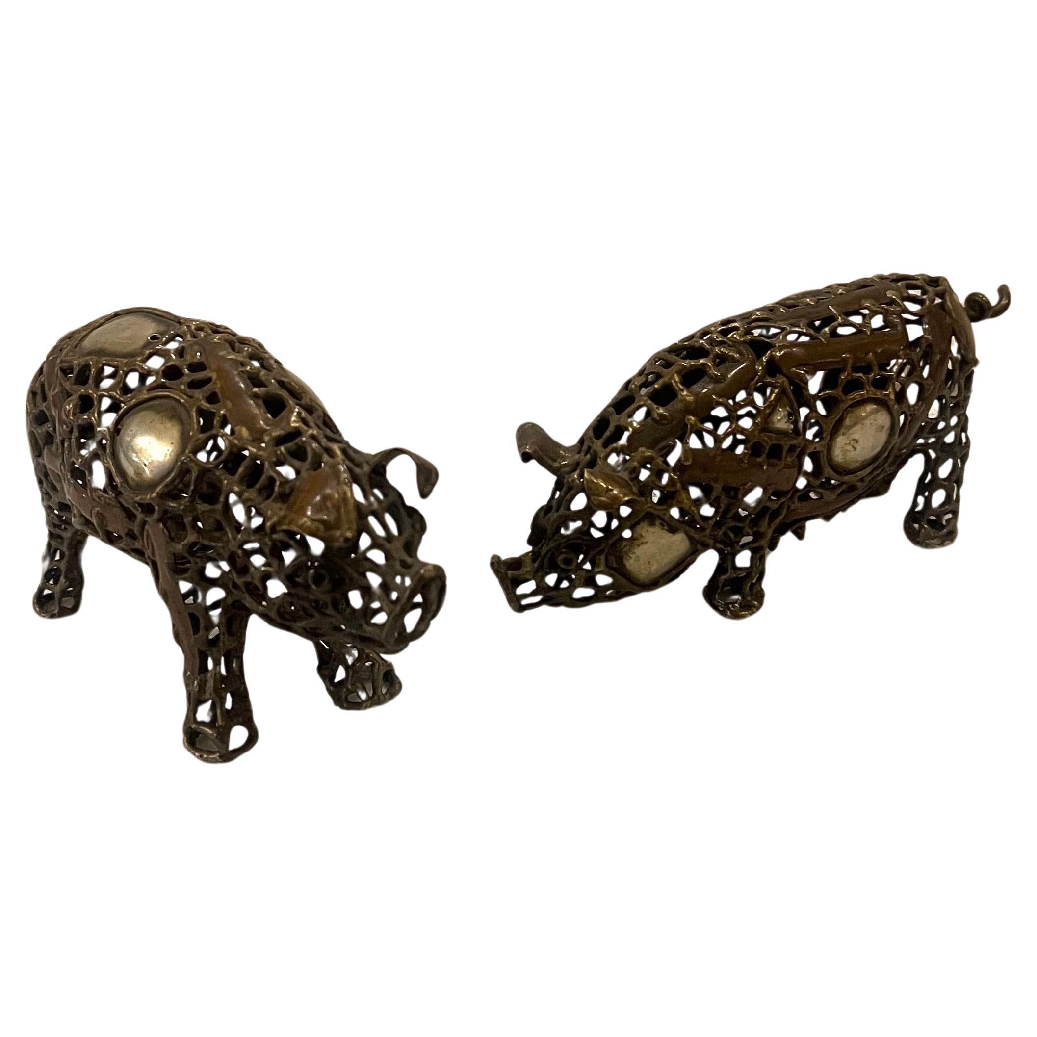 Whimsical pair of small pigs sculptures in bronze , copper , silver mix metals attributed to Mexican artist Pal Kepenges circa 1970's beautiful work .