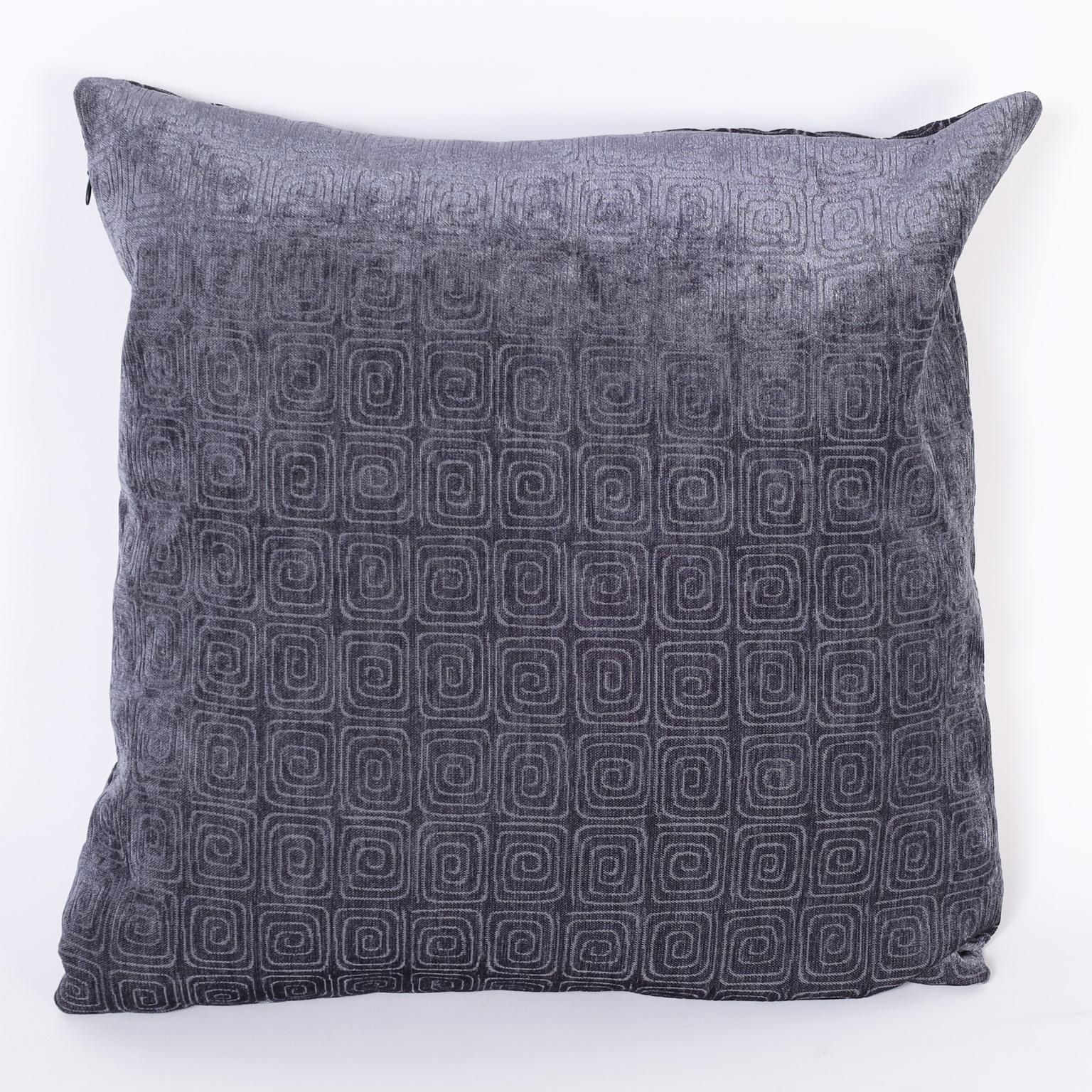 Pair of pillows crafted in velvetine relief with a repeating modern design.