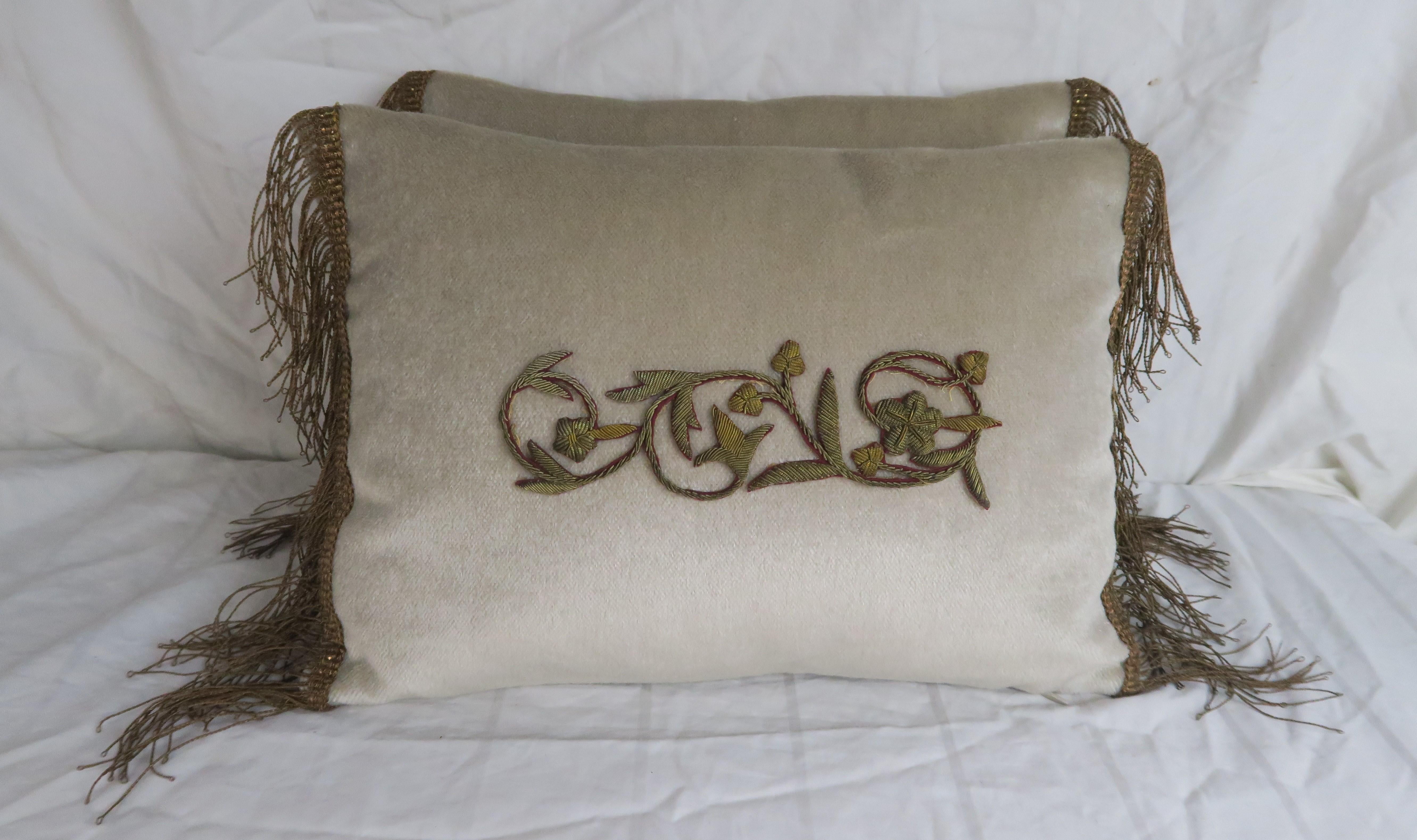 Pair of custom pillows made with 19th century metallic embroideries appliqued on silk mohair. 19th century metallic trim at sides. Golden silk backs, down inserts, zipper closures.