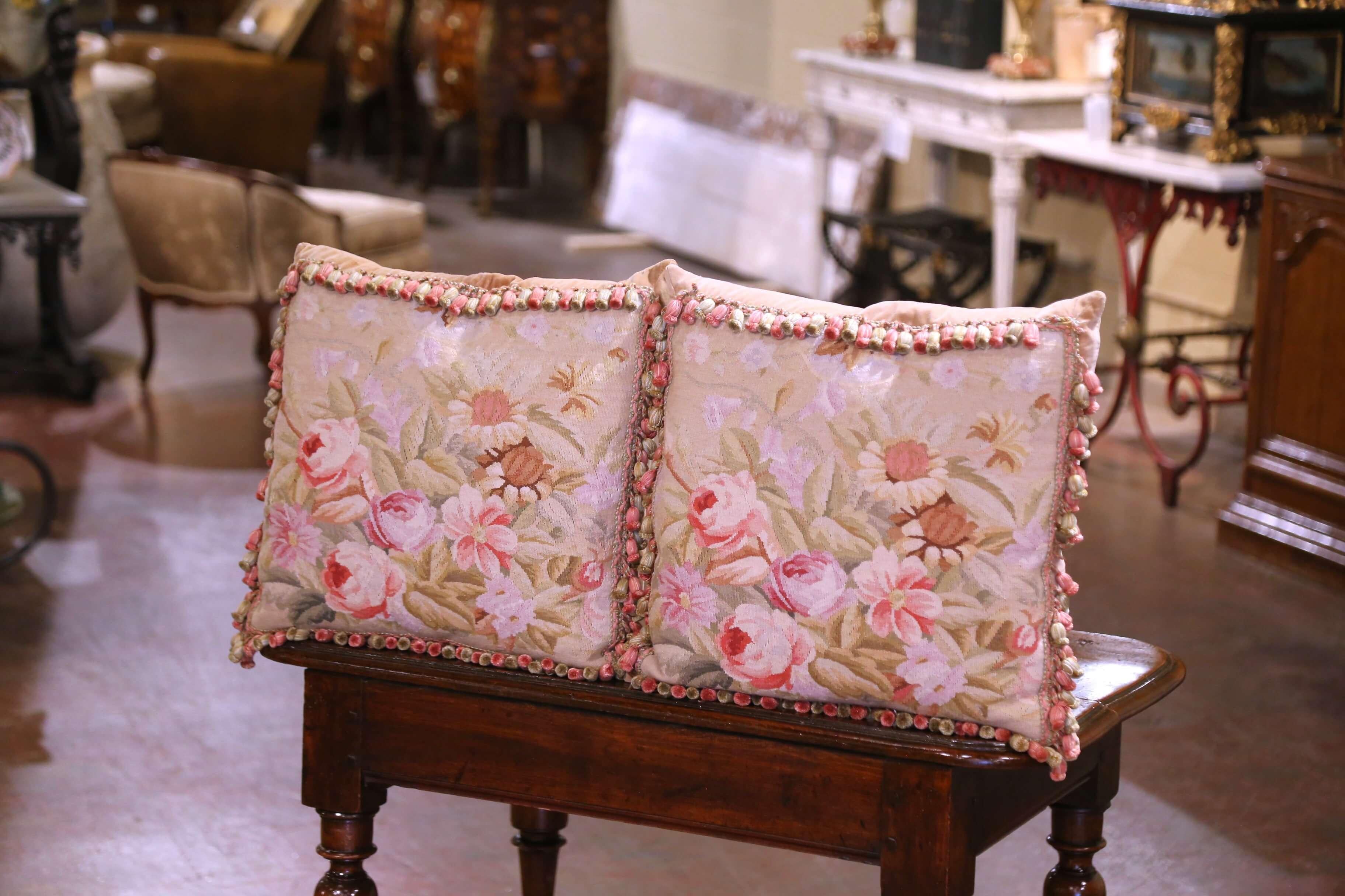This lovely pair of vintage floral tapestry pillows adds a touch of timeless charm to any traditional or country-inspired decor. Made with 19th century tapestry from Aubusson, France, each large pillow is handmade with complimentary trim and tassels