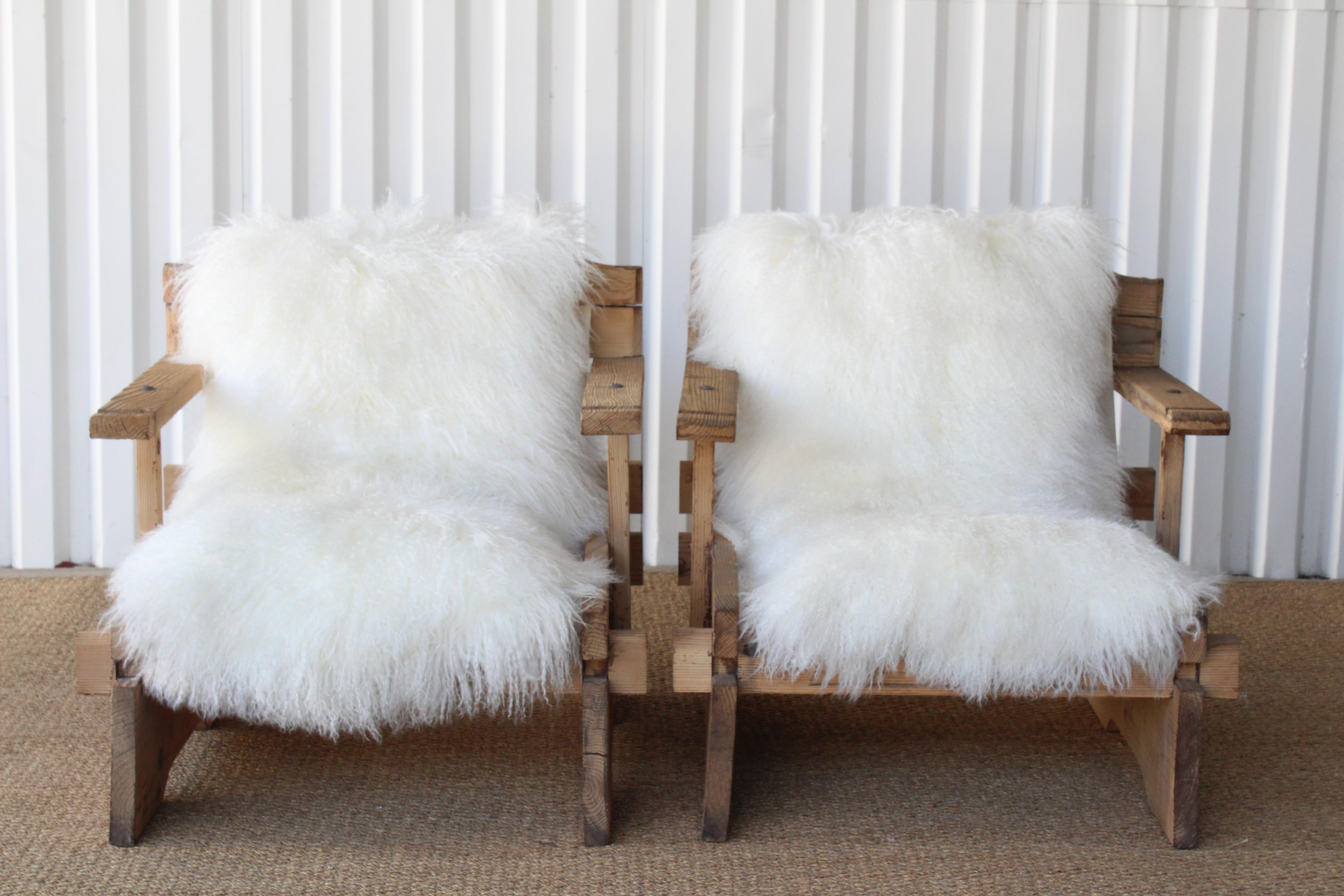 Pair of vintage one of a kind custom lounge chairs made of solid pine. From California, circa 1970s. Newly upholstered in long hair Mongolian lamb shearling hides and new canvas slings. The pine wood frames have been stripped and sand blasted and