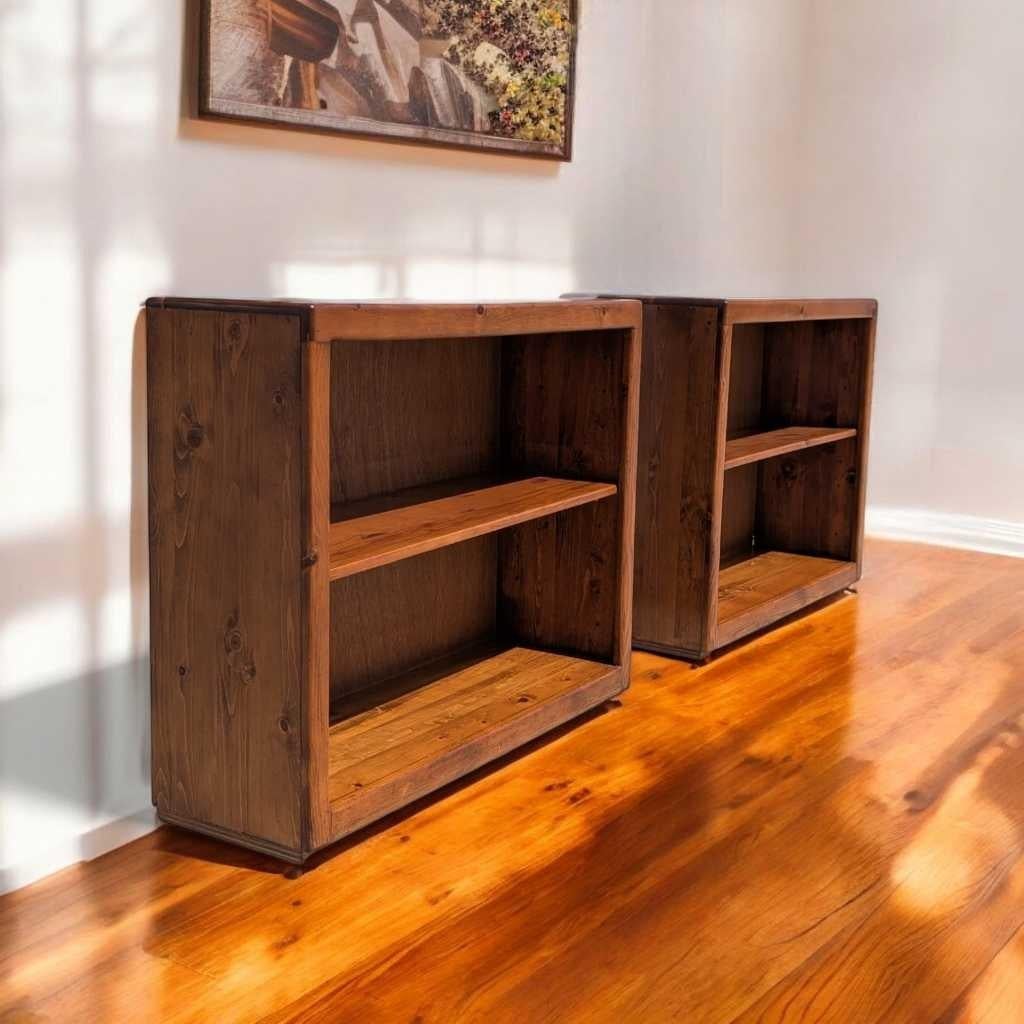 A versatile pair of solid pine bookcases, crafted in the 1970s–1980s and offering simple, functional elegance with natural wood grain and adjustable shelves. These low-profile bookshelves feature clean lines and a rustic warmth, ideal for farmhouse,