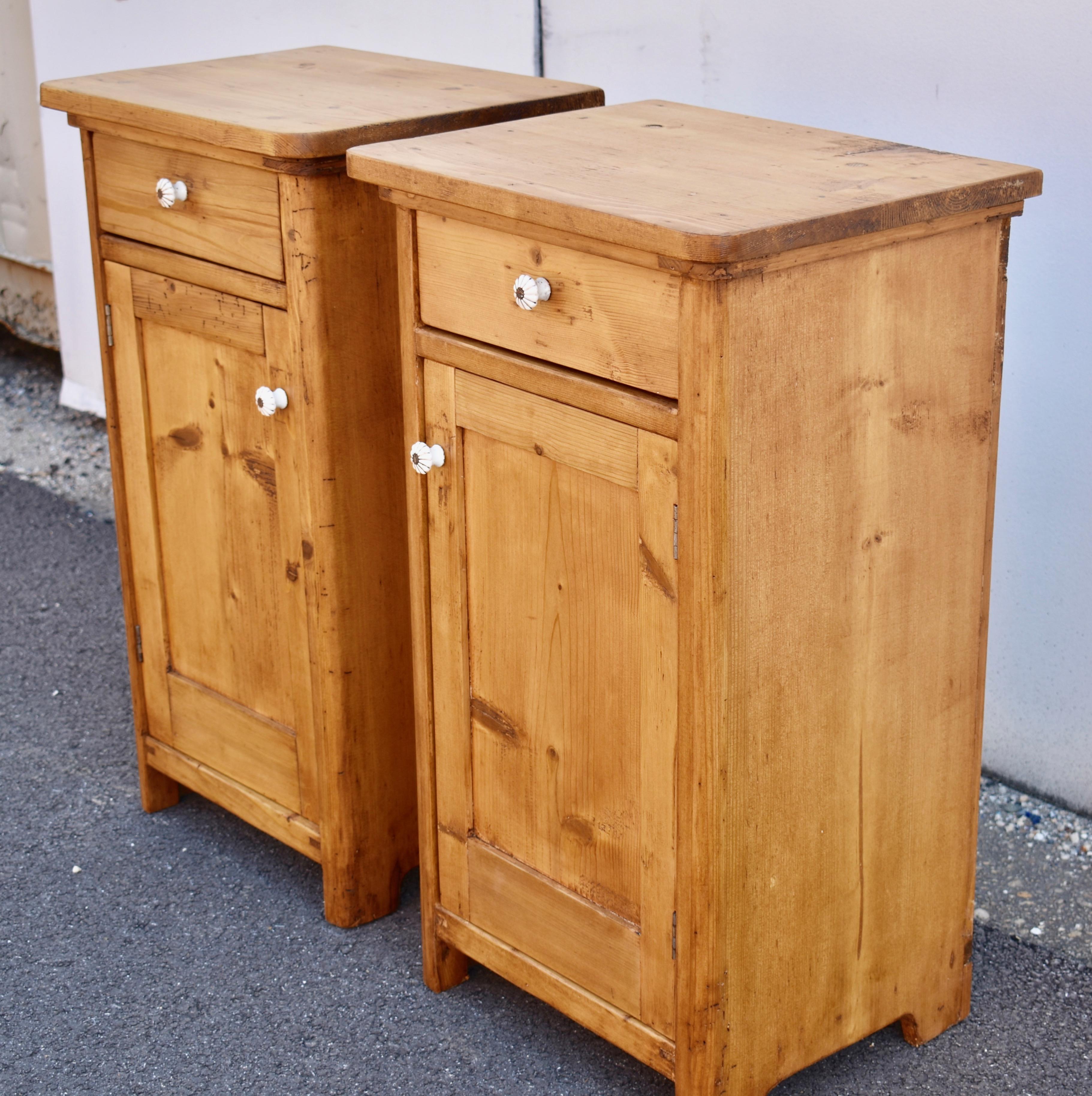 This is a matched pair of heavy pine nightstands with thick, sturdy tops, rounded at the front corners.  The drawers have lovely hand-cut dovetails and the doors have a single flat panel as is customary with such pieces.  There is a single shelf to