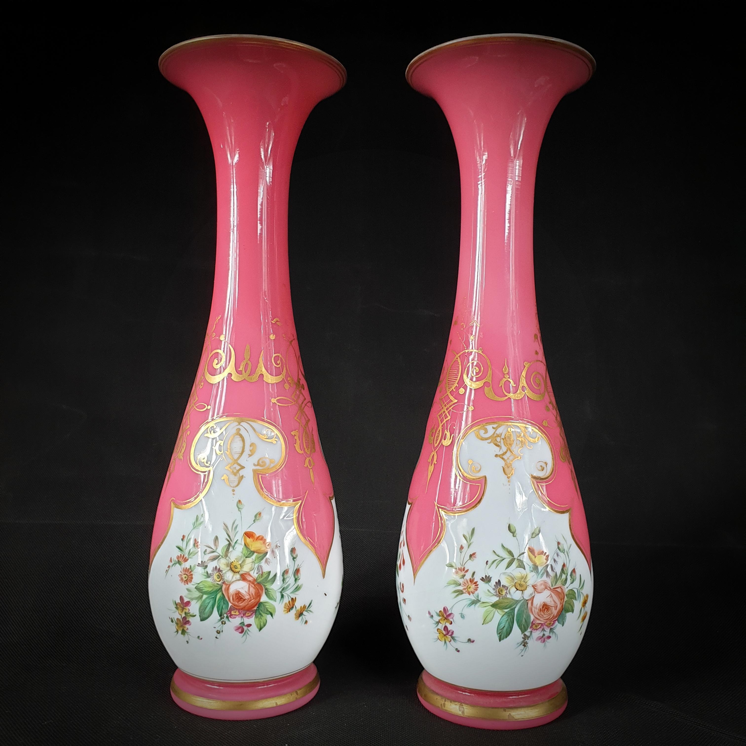 Bring a touch of vintage charm to your living space by bringing home this remarkable pair of opaline glass vases! These translucent drop-shaped vases, handcrafted in France between 1850 and 1900, have an enchanting white paint finish and are
