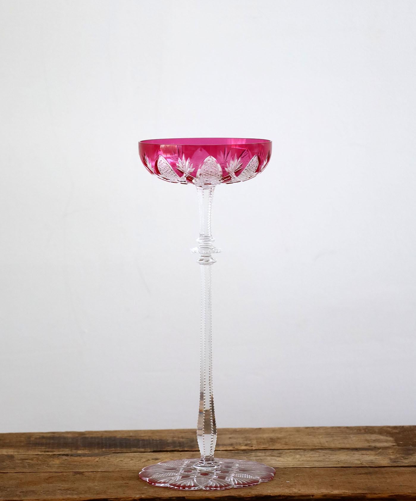 Created for Tsar Nicholas II, this clear crystal bowl - overlaid in coloured crystal with a high stem, a scalloped base, and diamond and palm leaf decorations - is spectacular. This exceptional set won over many aristocrats in the Imperial Court and