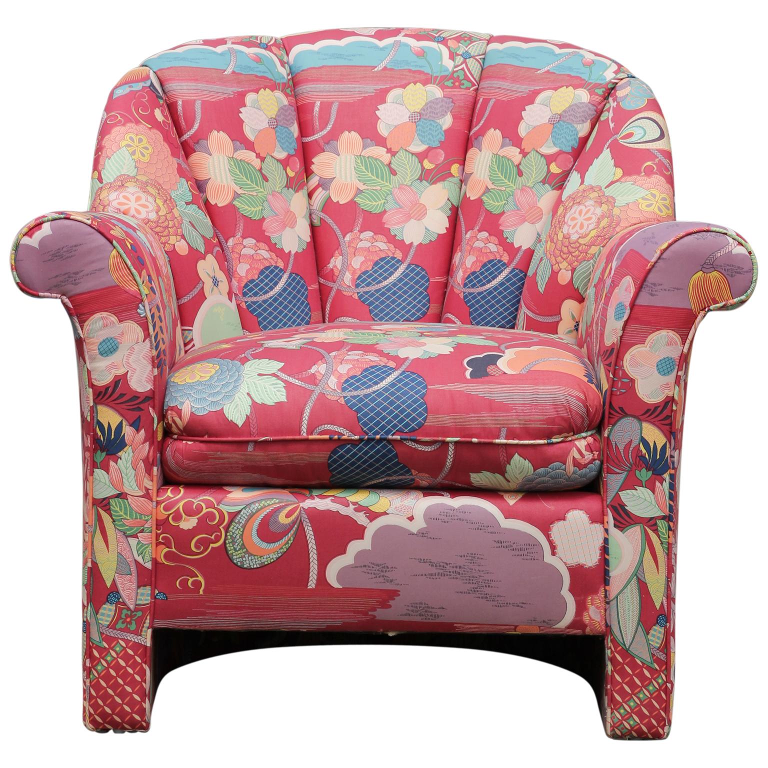 Pair of pink channel back chairs upholstered in pink colorful floral fabric. Under the cushion is a John Mascheroni for Swaim Originals.