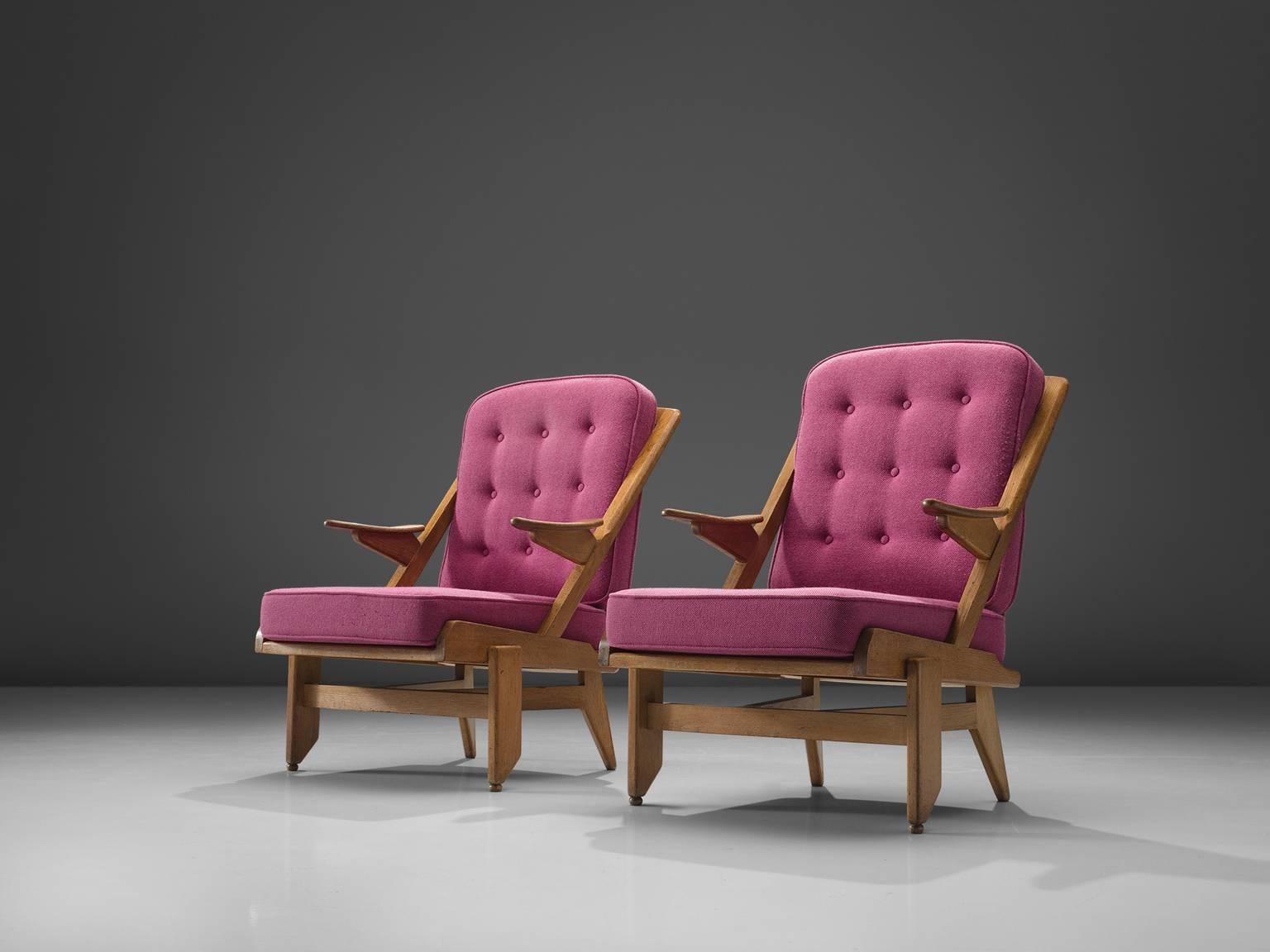 Guillerme and Chambron, pair of lounge chairs, pink fabric and oak, France, 1950s. 

This French designer duo is known for their extreme high quality solid oak furniture, from which this pink set is another great example. These chairs have a very