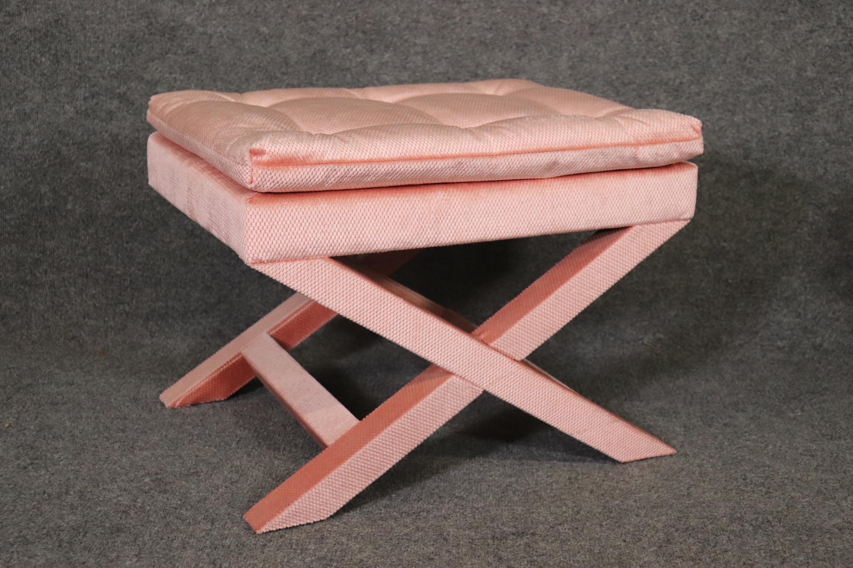 This Pair of Dorothy Draper Style X Benches are upholstered in high quality pink fabric the seats are tufted. They are from the late 90's and will add a luxurious yet minimal touch to your home or office! The benches are in great condition and don't