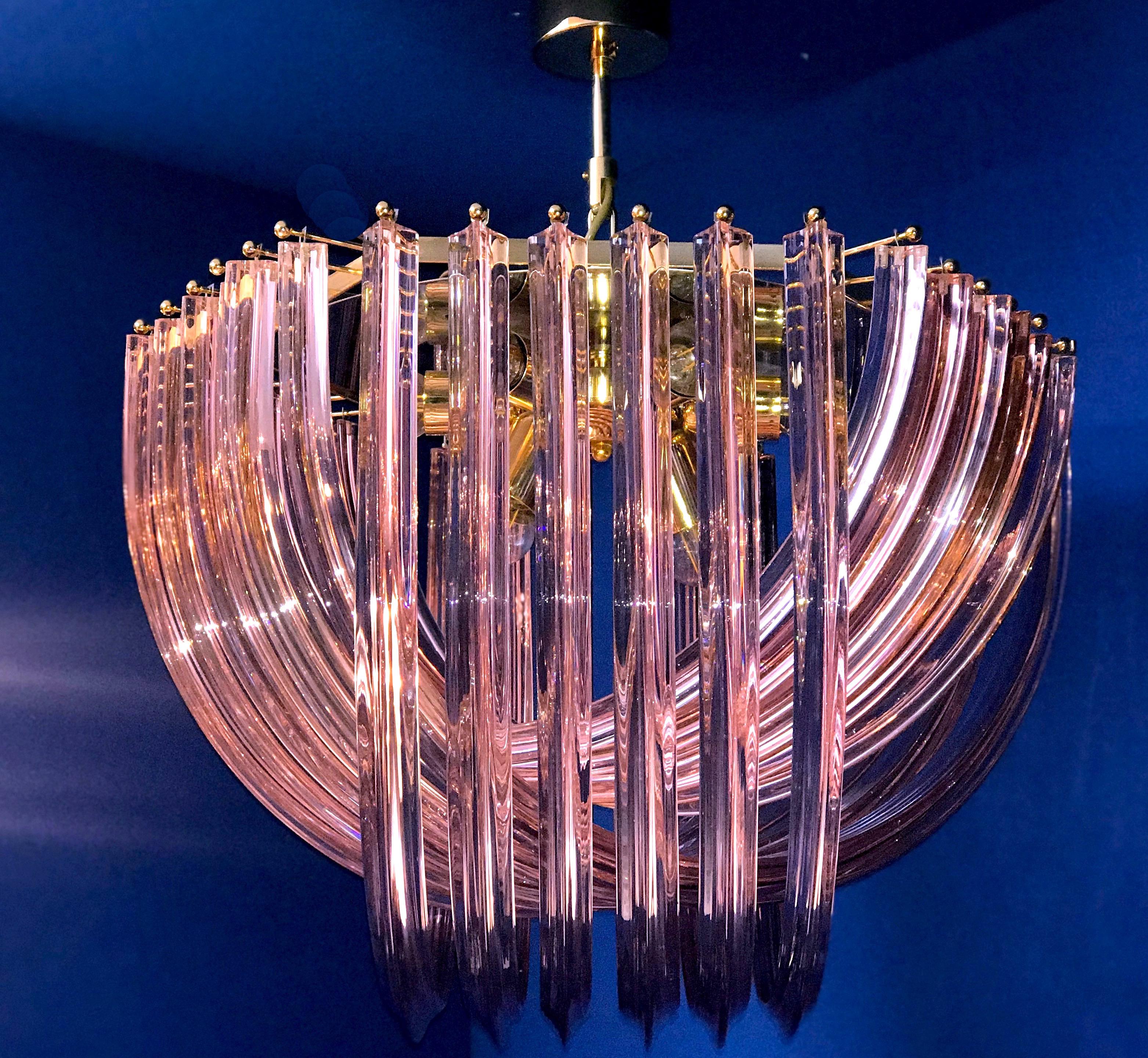 Amazing pink Murano glass chandelier or ceiling light with four layers of curving “triedri” glass prisms on an octagonal brass frame. A dynamic form, changing as you move around it, due to the overlapping levels of transparent glass with a fabulous
