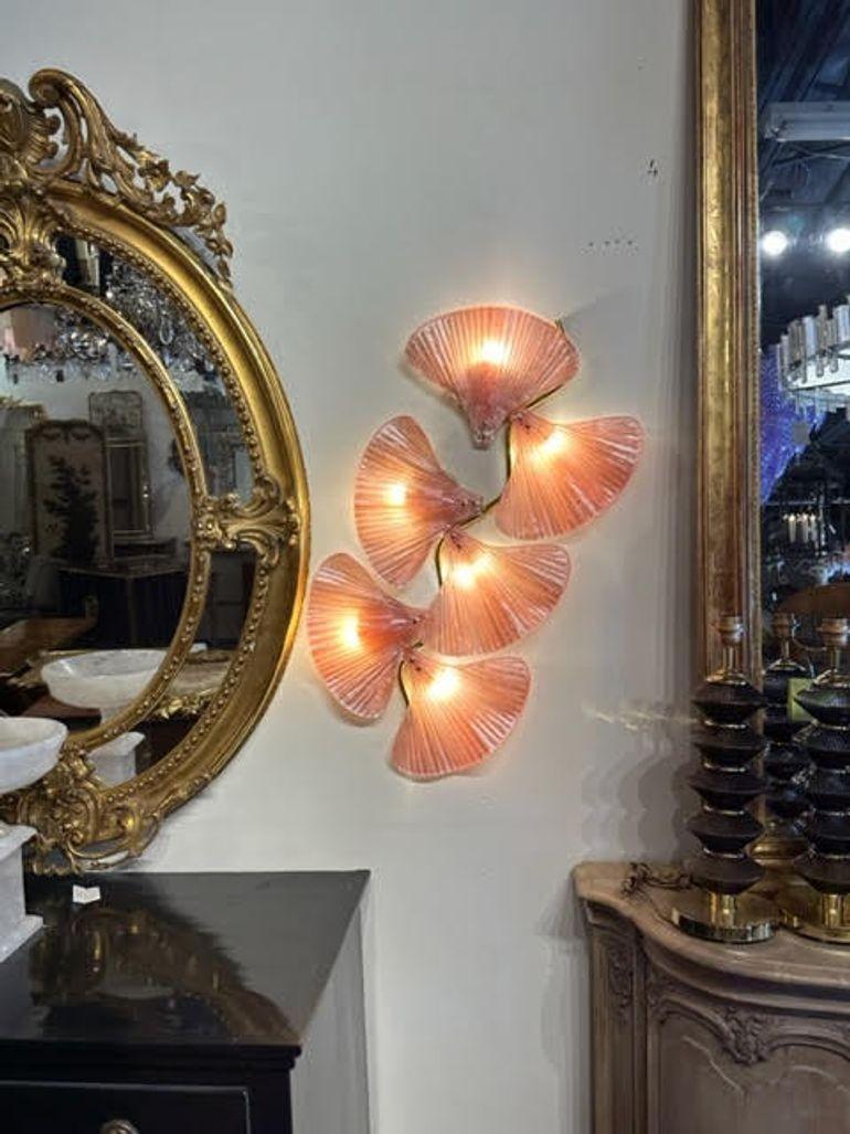 Gorgeous pair of pink Murano glass and brass fan shaped sconces. Creates a fabulous upscale look that is sure to impress! Amazing!