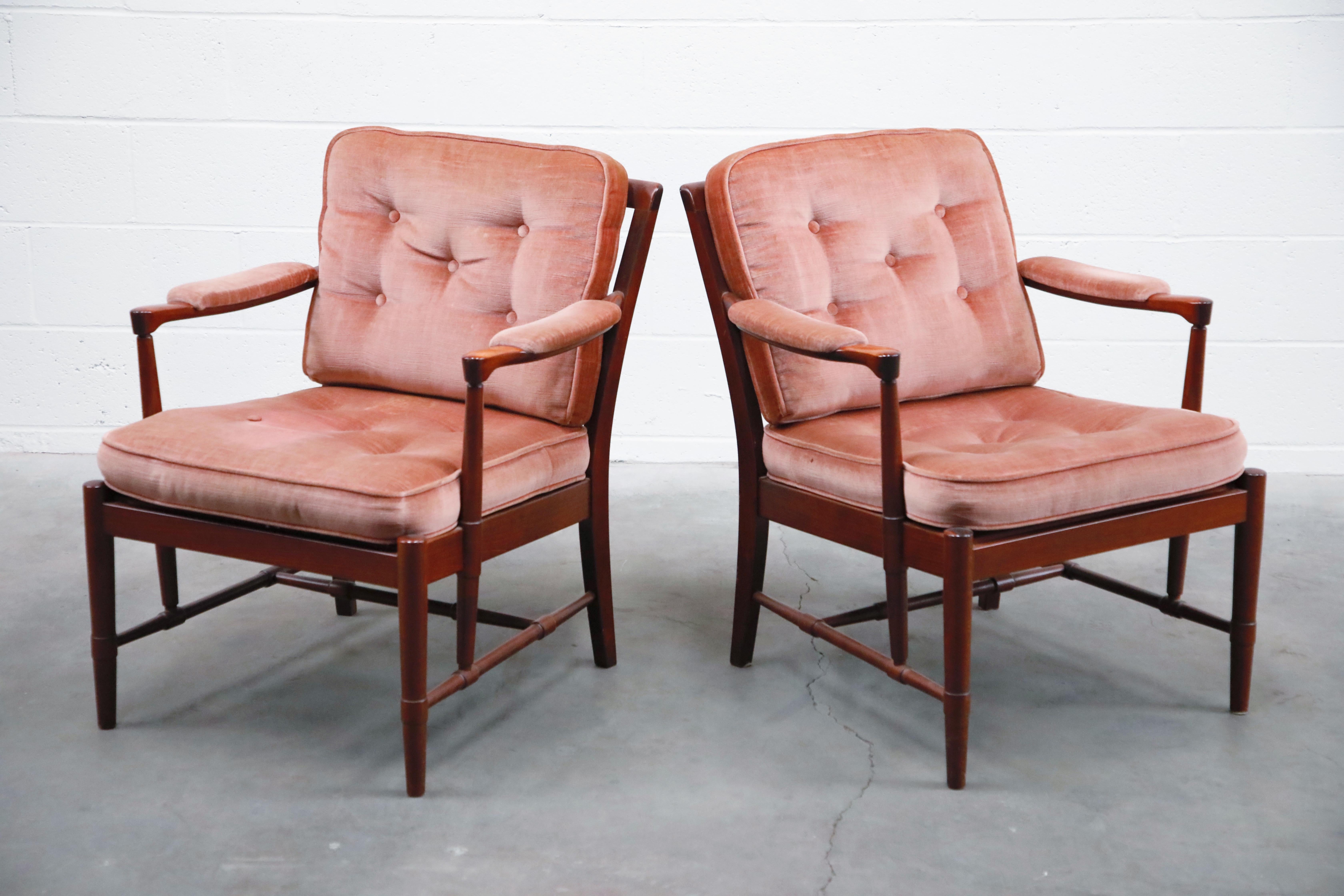An incredible pair of Danish modern rosewood and pink velvet armchairs by Aksel Sorensen Mobler. These 1970s Denmark lounge chairs feature sculpted wood with beautiful rosewood grain and design features including sculpted arms, innovative turned