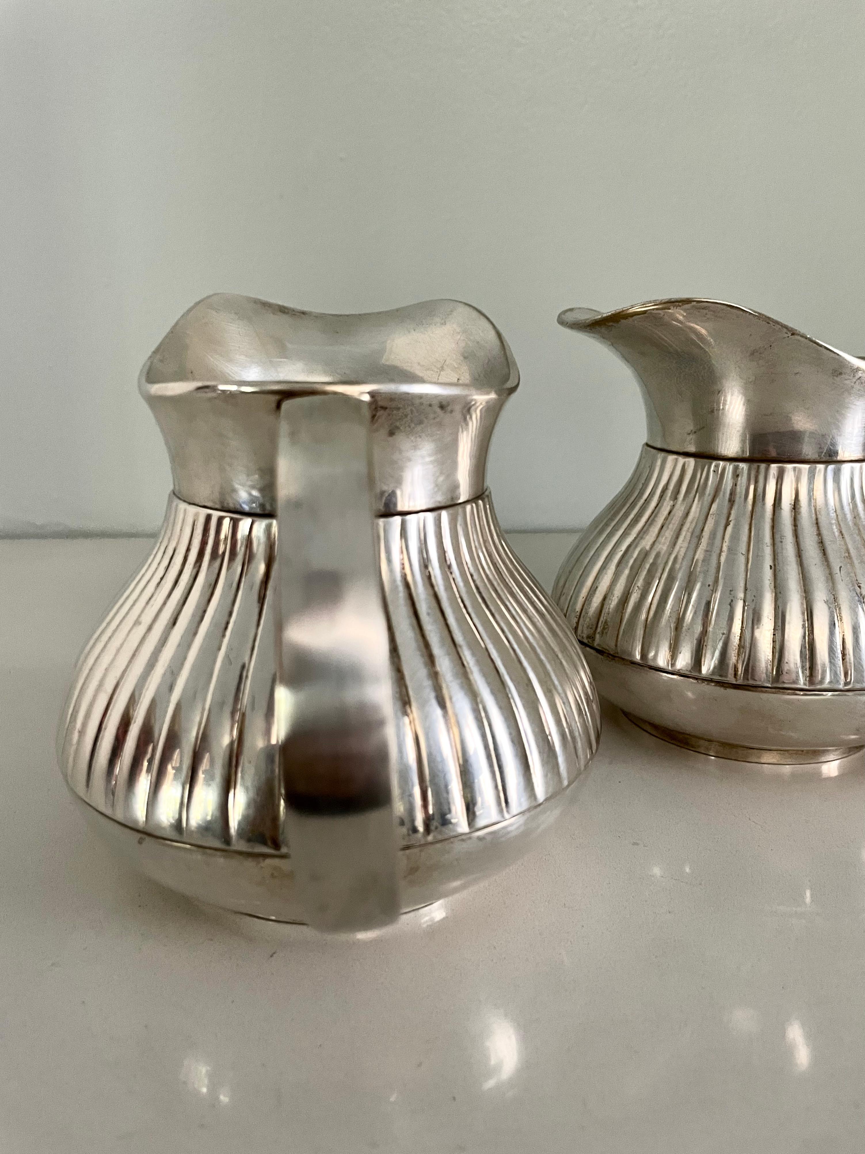Art Deco Pair of Pinstriped Silver Pitchers For Sale