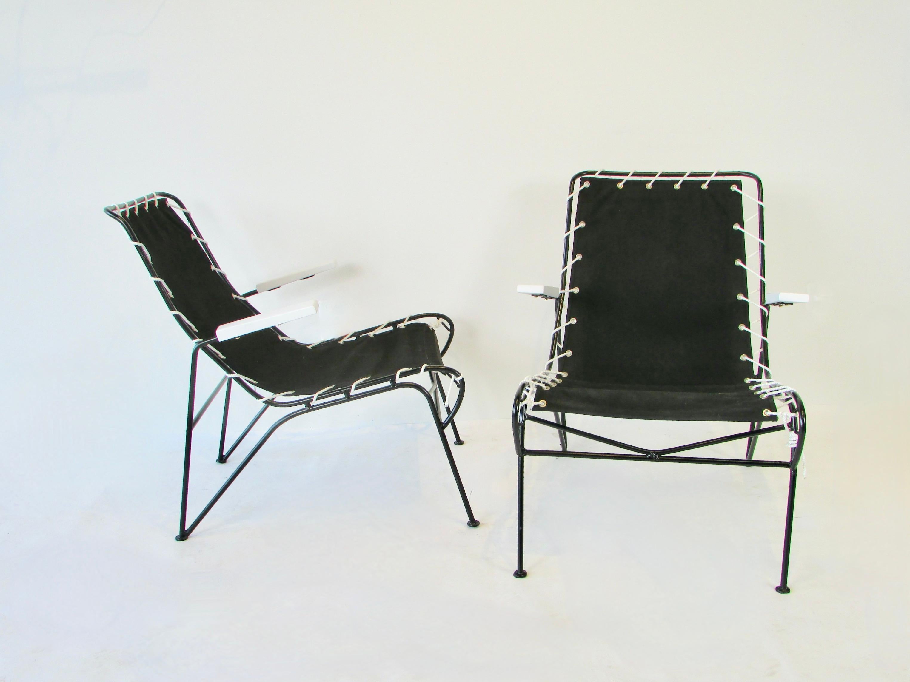 Pair of lounge chairs from the Ficks Reed Sol - Air line. Designed be husband wife team of Pipsin Saarinen and Robert Swanson. Black powder coated wrought iron frames hold white lacquered wood arms wrapped with white cord holding black canvas