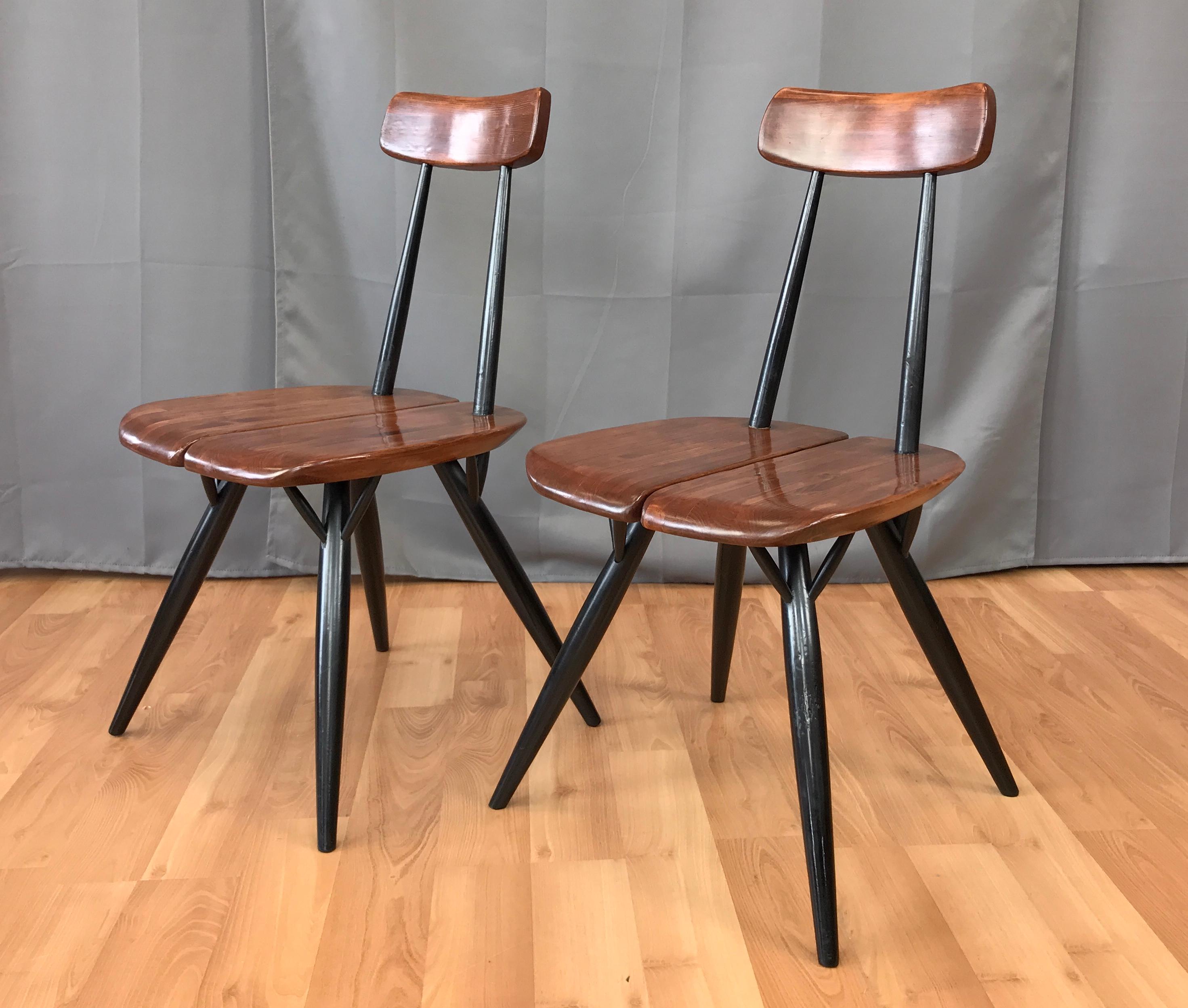 A pair of Ilmari Tapiovaara design dining chairs, from the furniture series 