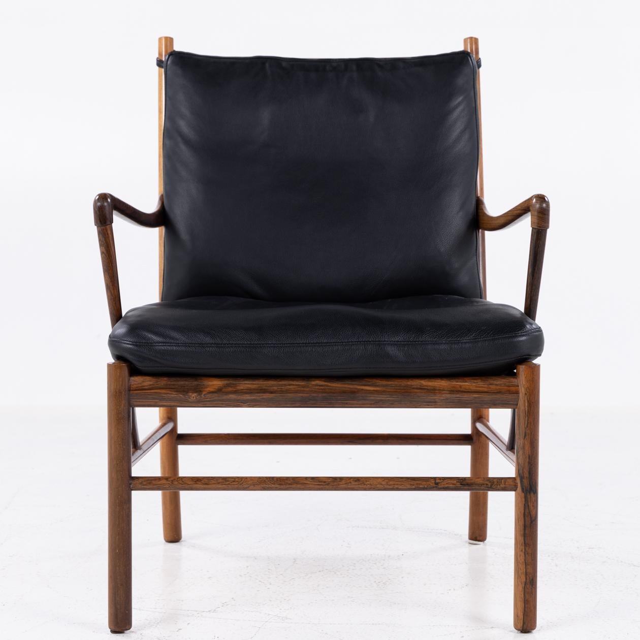 PJ 149 - 'Colonial Chair' easy chair in rosewood and cushions in black leather. Labelled from manufacturer PJ Furniture.
Designed by Ole Wanscher.