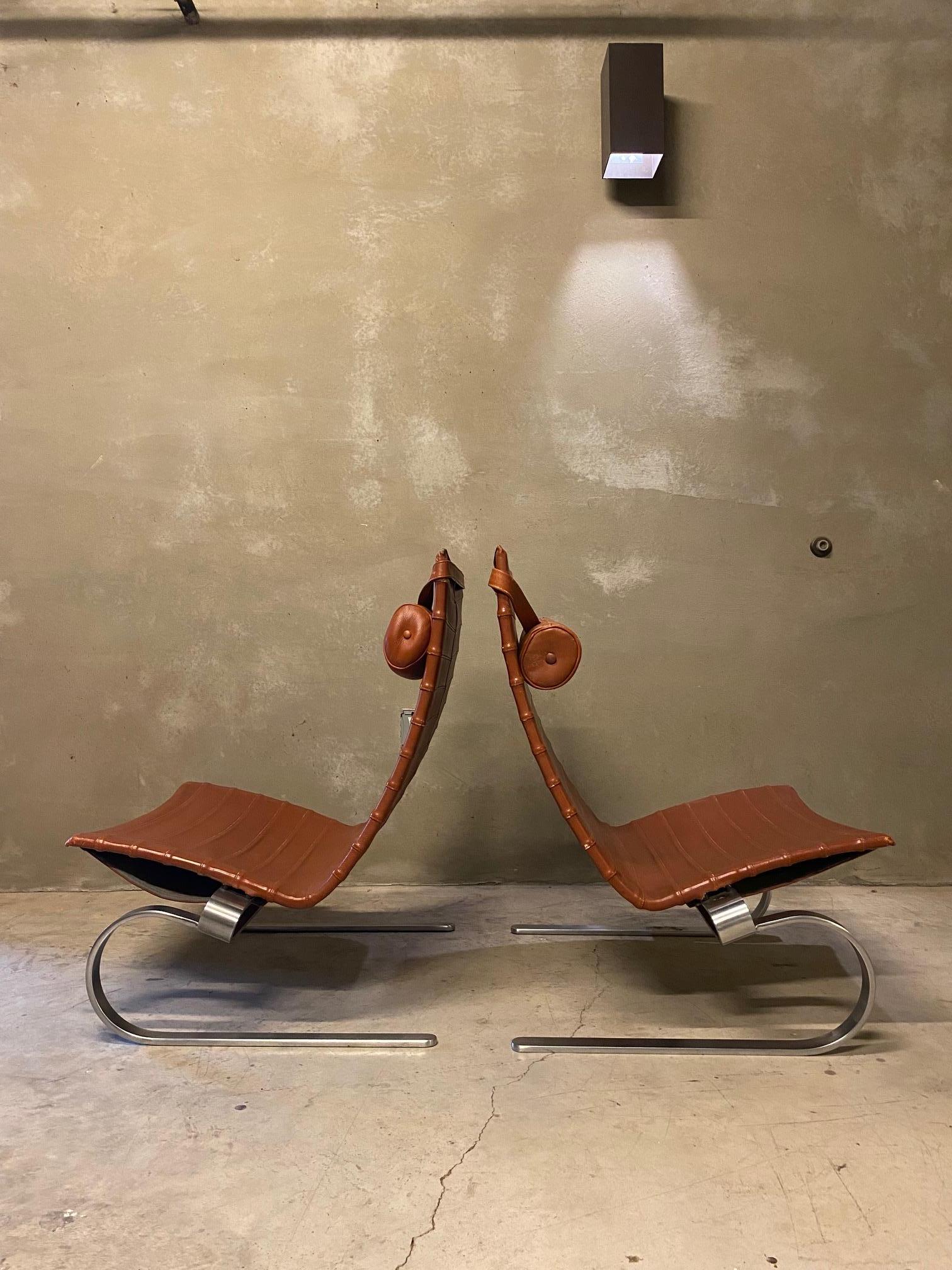 Highly collectible pair of rust leather and chrome PK20 lounge chairs by Poul Kjærholm.    Originally designed in 1968, these examples were manufactured by Fritz Hansen.  Fine examples of Scandinavian Modern design.  Headrests are removable.  Very