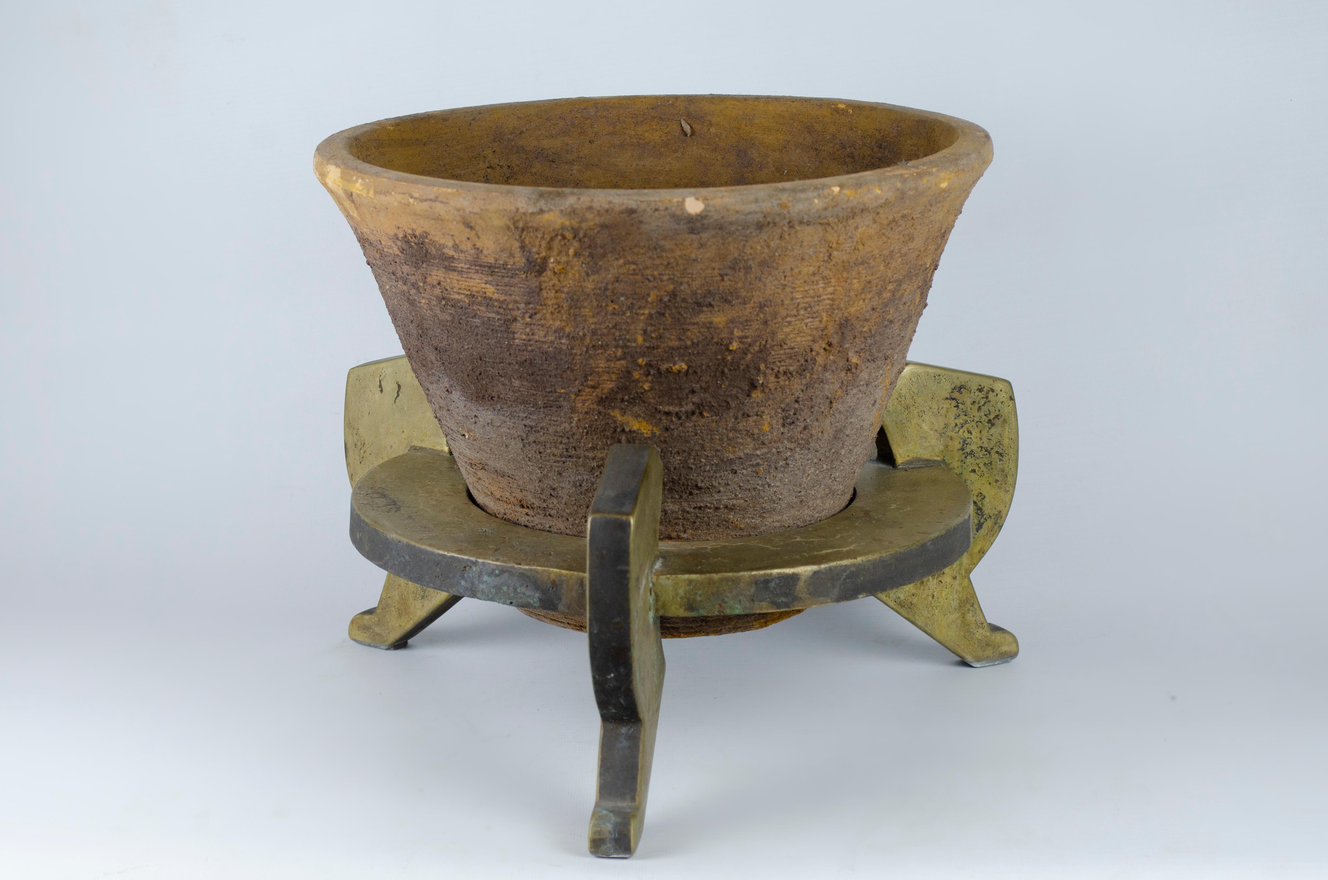 Pair of planters made by Marc Du Plantier (1901 -1974). The design has an Egyptian inspiration, the pots are made of terracotta and the base is bronze with an oxidized patina.

They were reproduced in the ALB Antiquities Gallery in