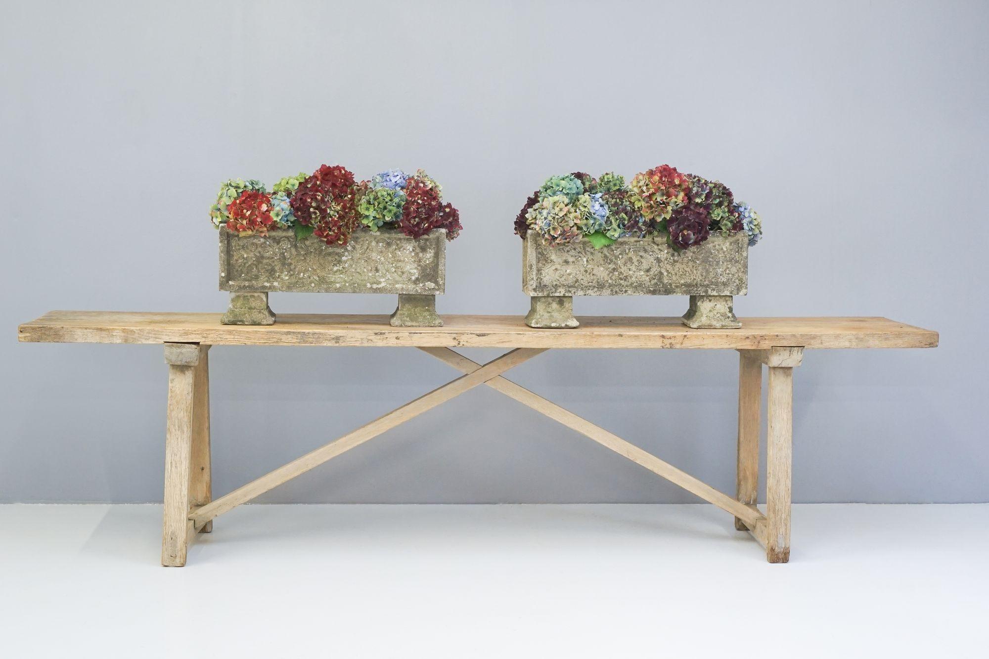 Pair of double sided oblong concrete planters on feet.
H 29cm x W 65cm x D 20cm
