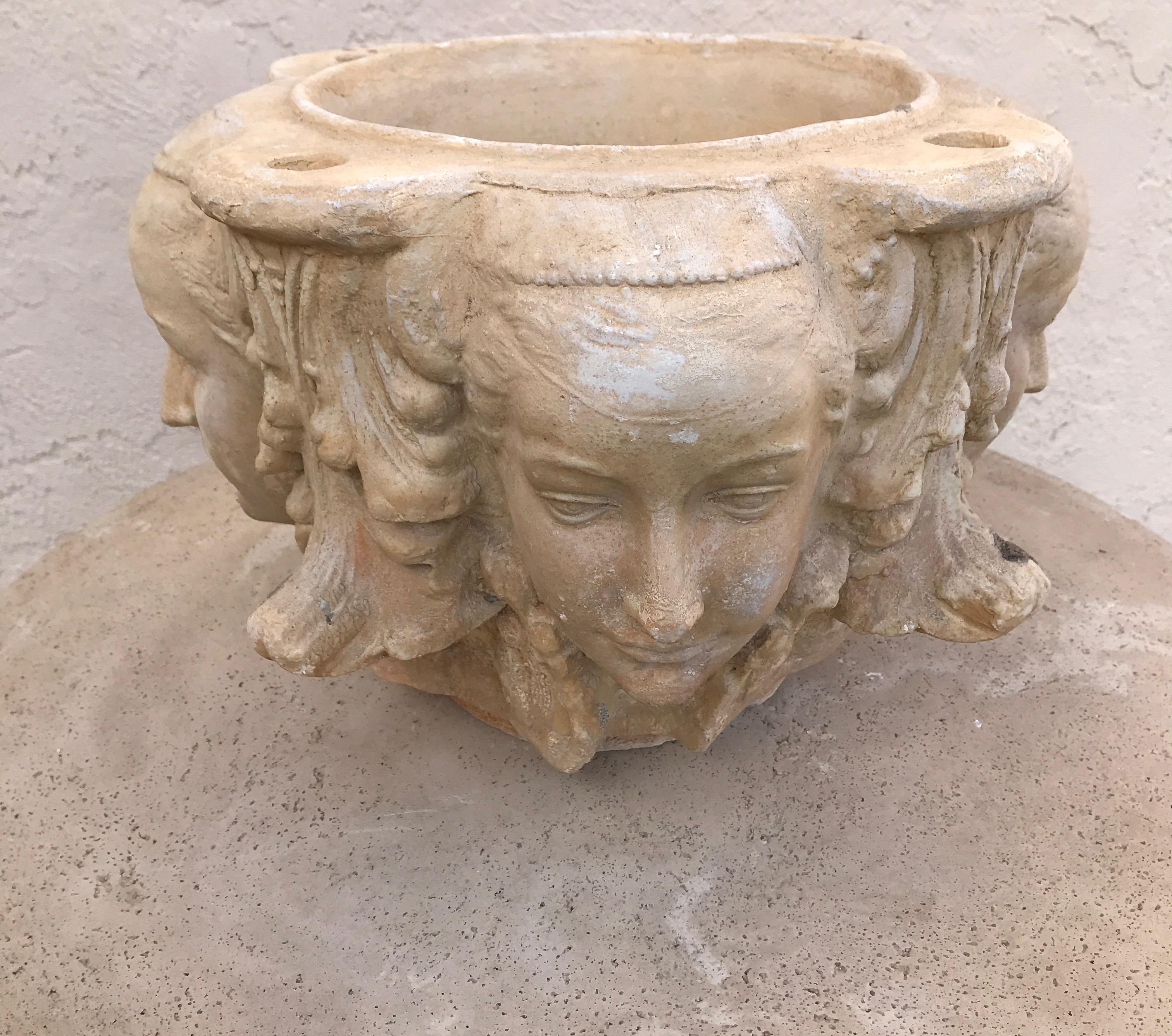 Cast Stone Pair of Planters with Four Candle Holes and Faces on Each Side