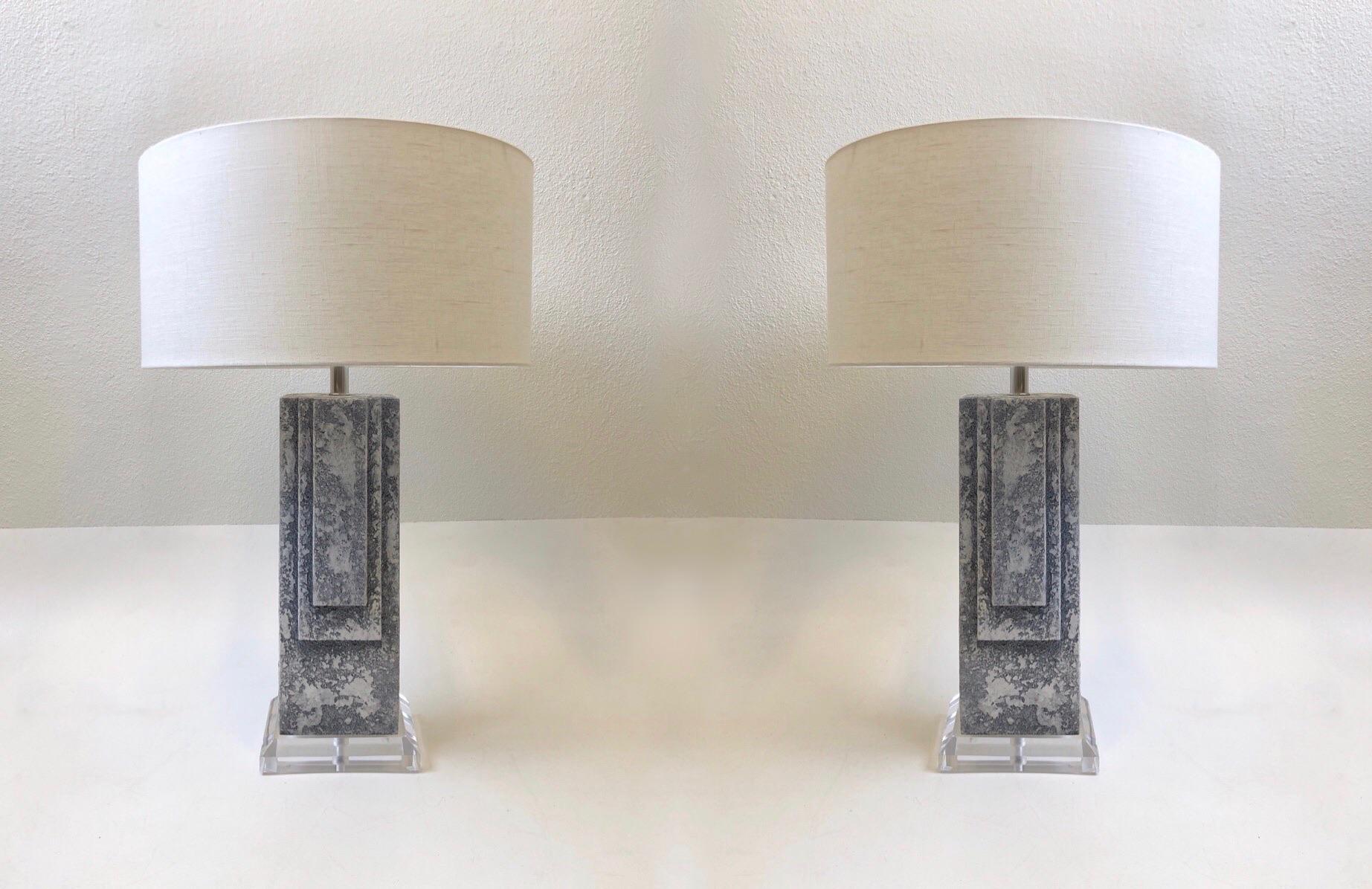Glamorous 1980s grayish blue plaster table lamps. They are constructed of white plaster with a gray blue wash finish on an acrylic base. Newly rewired with polish chrome hardware and new vanilla linen shades
Measurements: 20” diameter, 30.25”