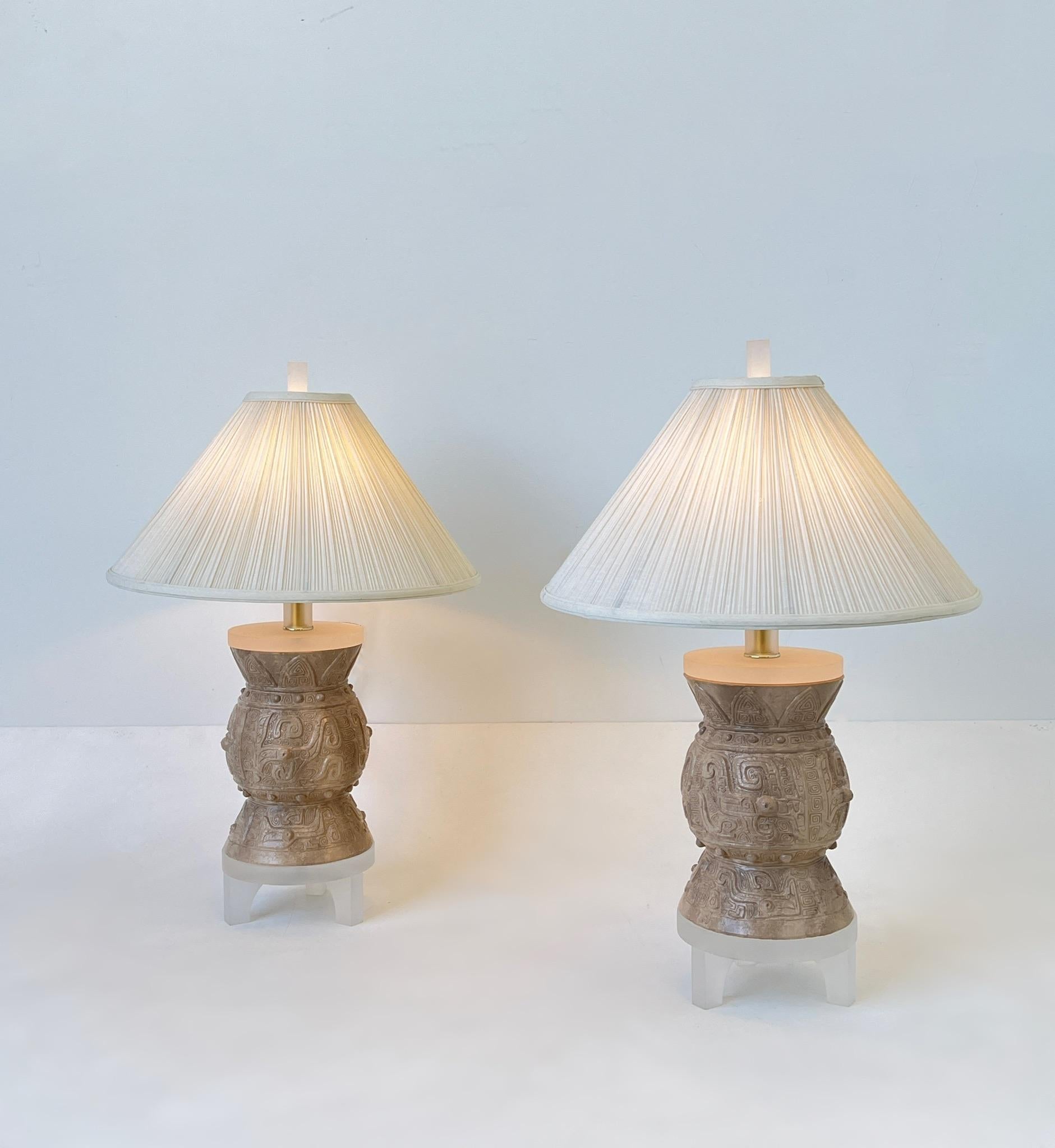 Glamorous 1991 pair of plaster and satin lucite with polish brass hardware table lamps by Bauer Lamp Co. 
New polish brass hardware, silk shades are original. 
Measurements: 19” Diameter, 27.5” High, 8” Diameter Base.