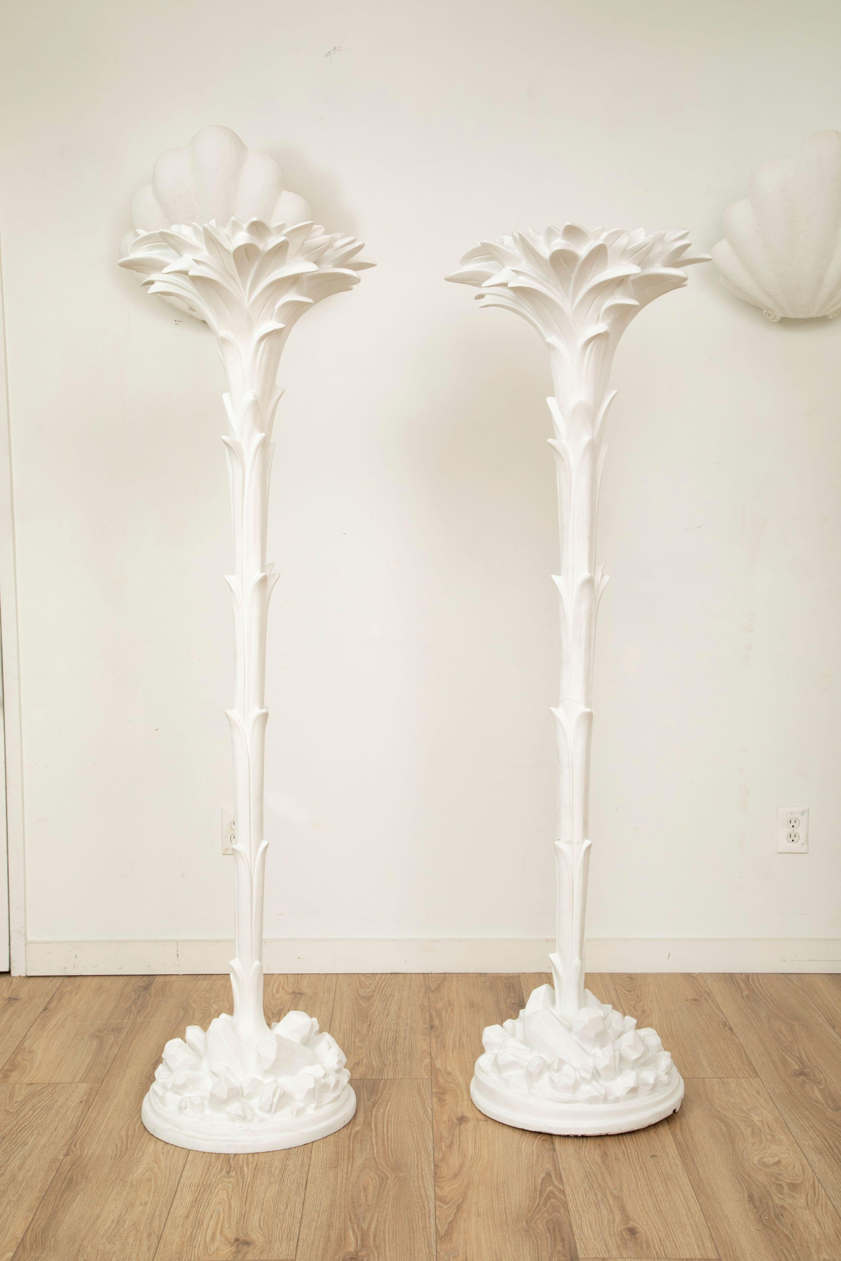 Pair of plaster palm form floor lamps, Serge Roche style, France, 1950s
Striking and sculptural pair of floor lamps crafted in plaster with a stylized palm frond motif. The tall fluted stems rise from rock-form bases and burst into lush, sculpted