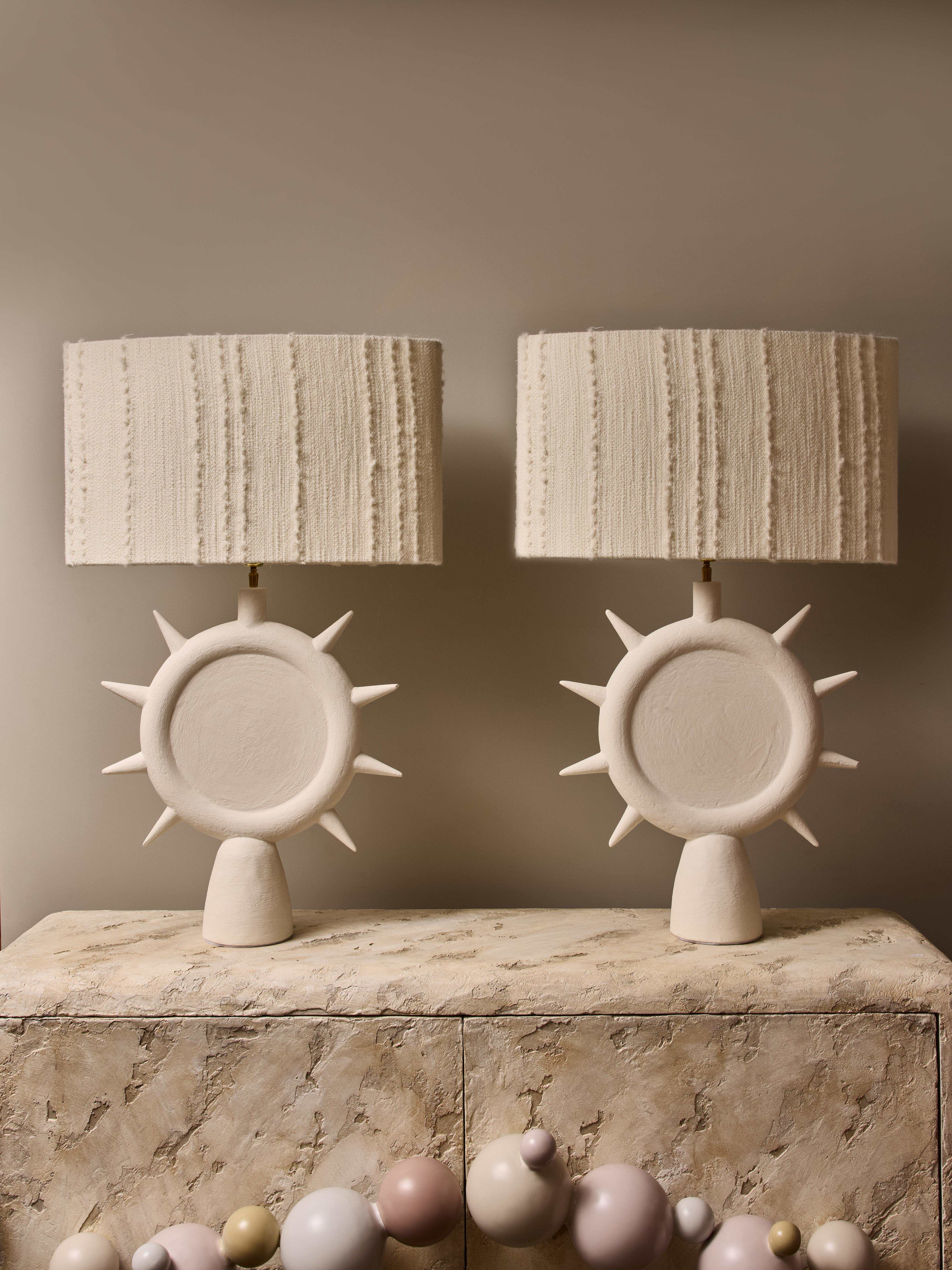 Pair of table lamps made of plaster, shaped like a sunshine with brass hardware. Topped with custom oval shades.

Dimensions with shades: 60x20H95cm