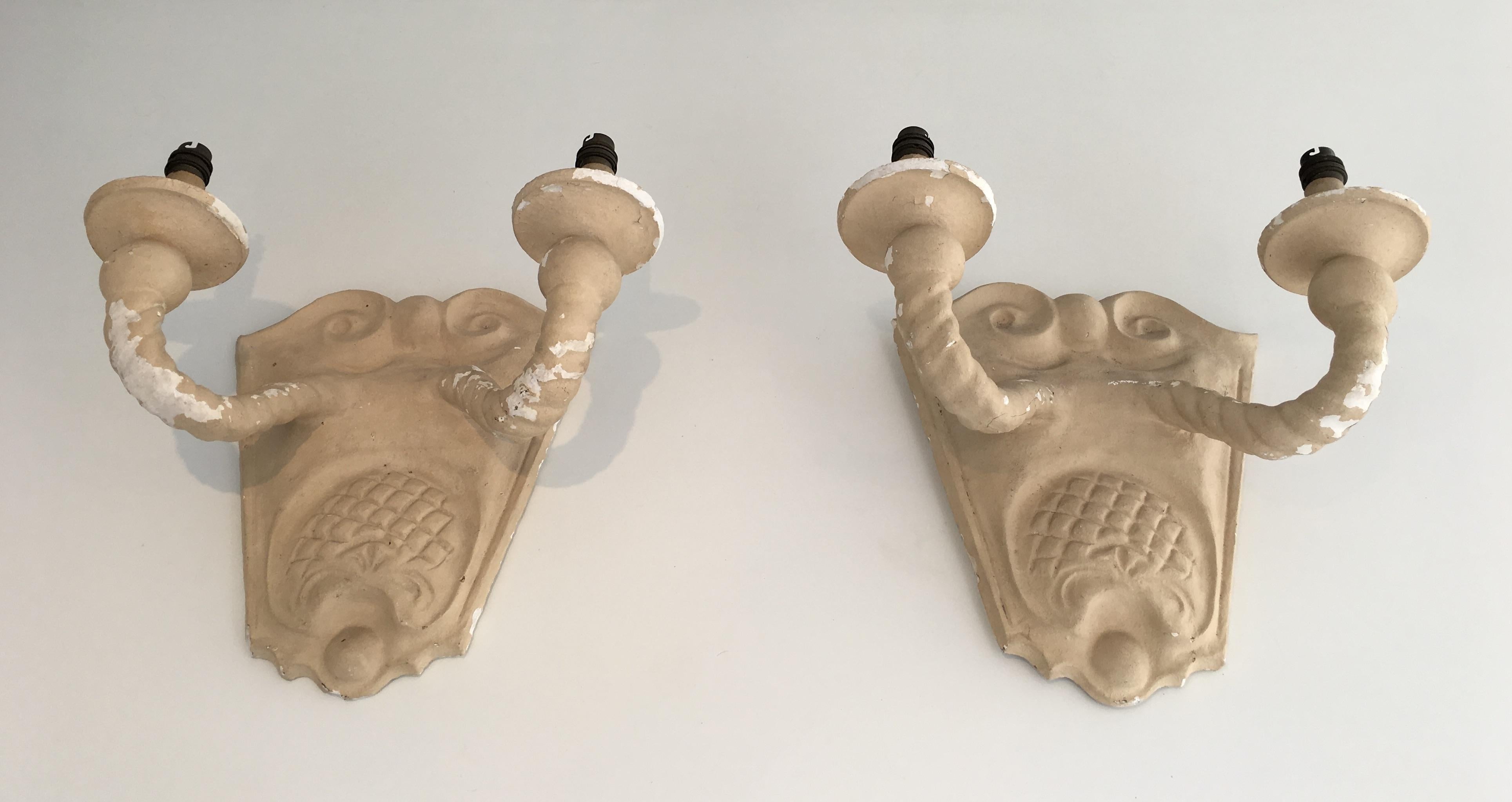 This pair of wall sconces is made of painted paster. This is an interesting model typical from the 1940s work. As shown on the pictures, the paint is off on some areas and the plaster is a bit used and damaged. There are some light cracks but the