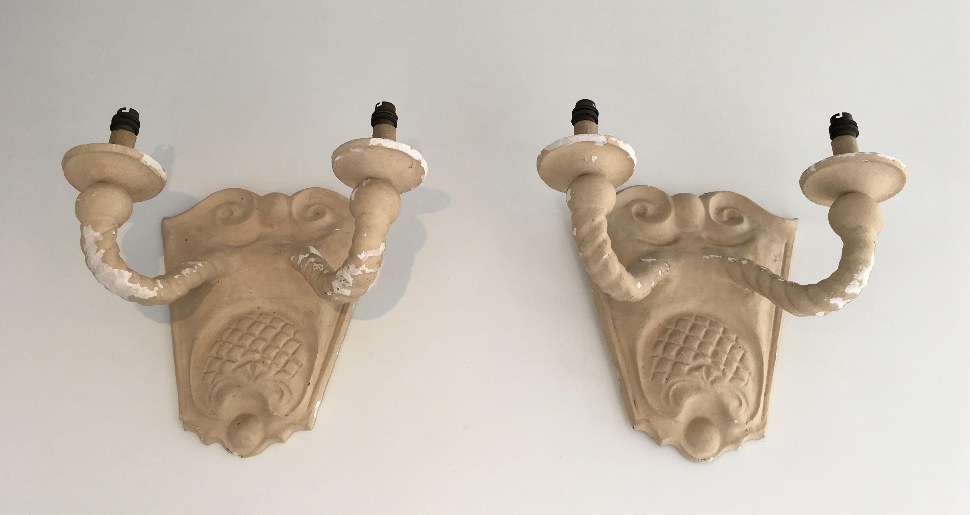 This pair of wall sconces is made of plaster. This is a French work in the style of circa 1940.