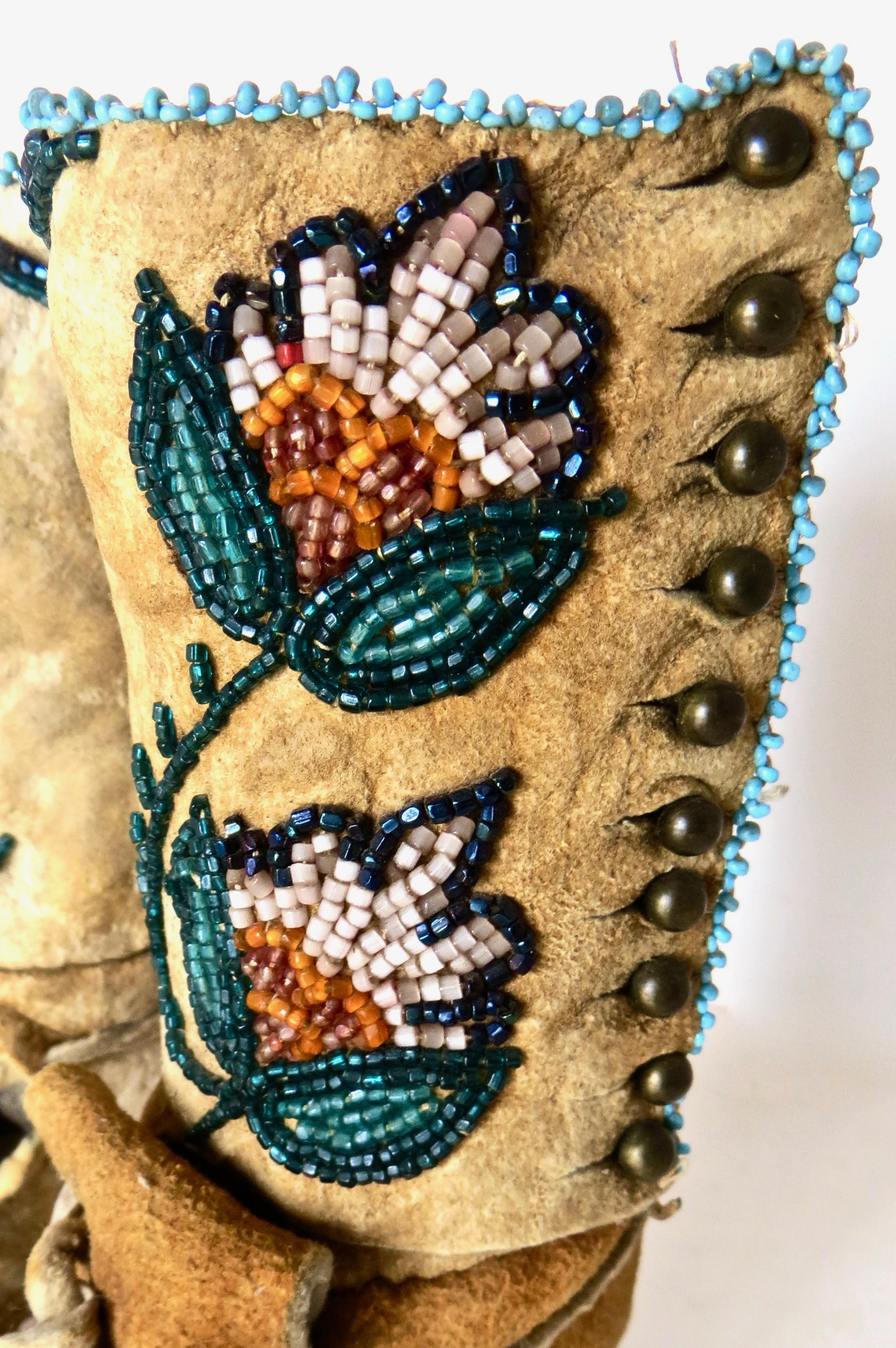 Native American Indian, probably Shoshone, these high top children’s moccasins are intricately constructed with delicate bead work and fine tanned leather with great attention to detail. They were made in the late 19th century, not for the tourist