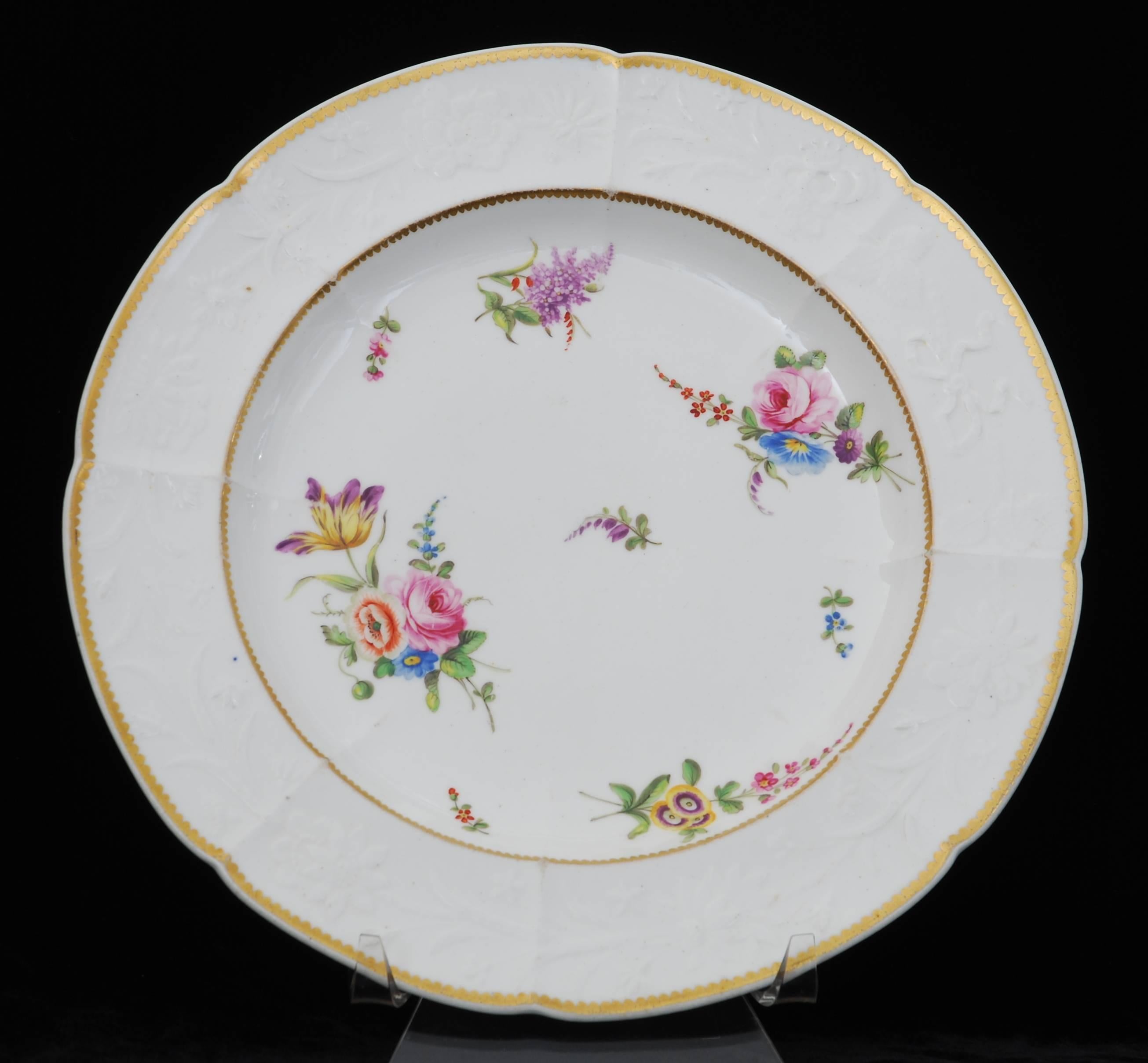 A fine pair of plates in the incomparable Nantgarw body; decorated in London with naturalistic sprays of flowers.