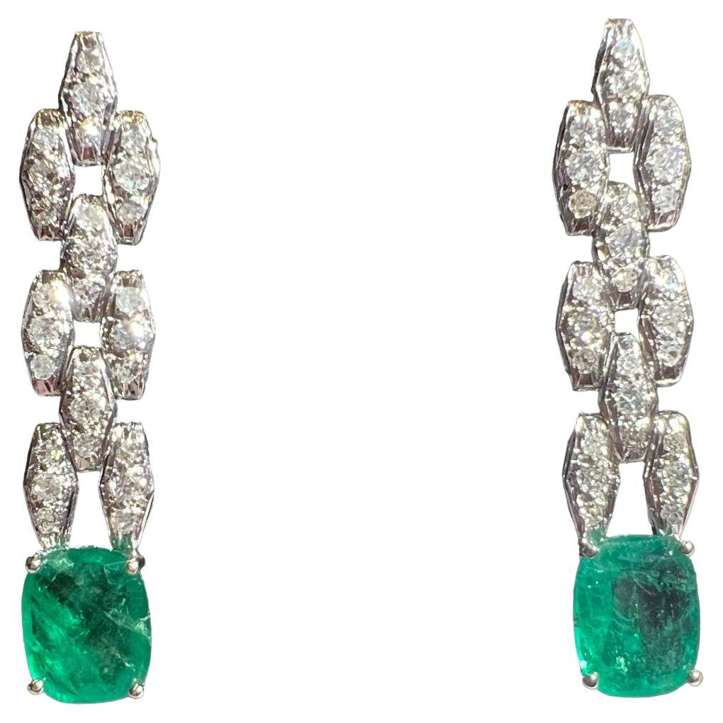 pair of platinum  earrings set with 2 emeralds and paved with diamonds