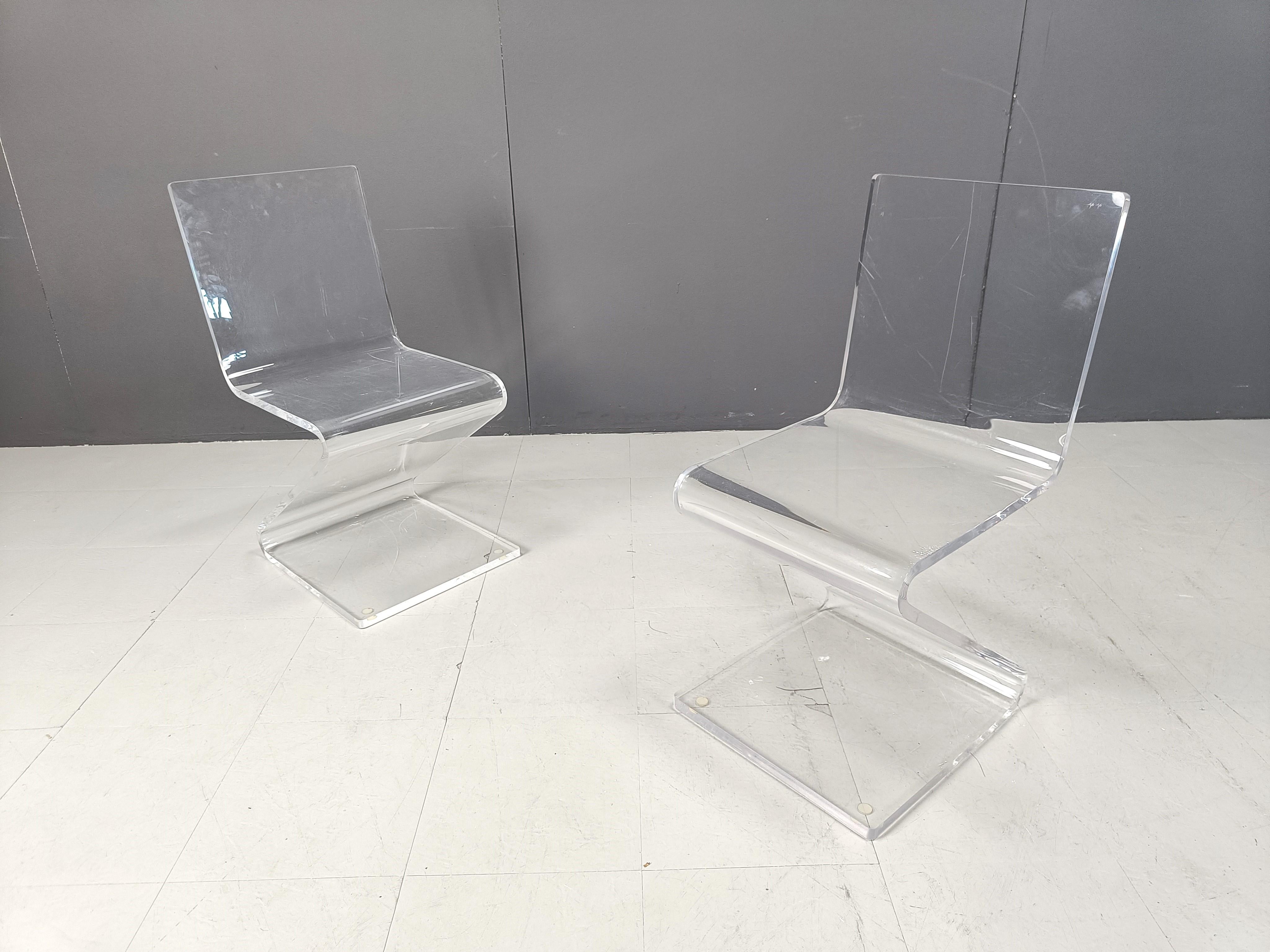 Pair of vintage plexi 'zigzag' chairs.

Beautiful, timeless design chairs.

19890s - Belgium

Dimensions:

Height: 79cm
Width: 38cm
Width: 40cm
Depth: 40cm

Price is for the set.

Ref.: 288922

