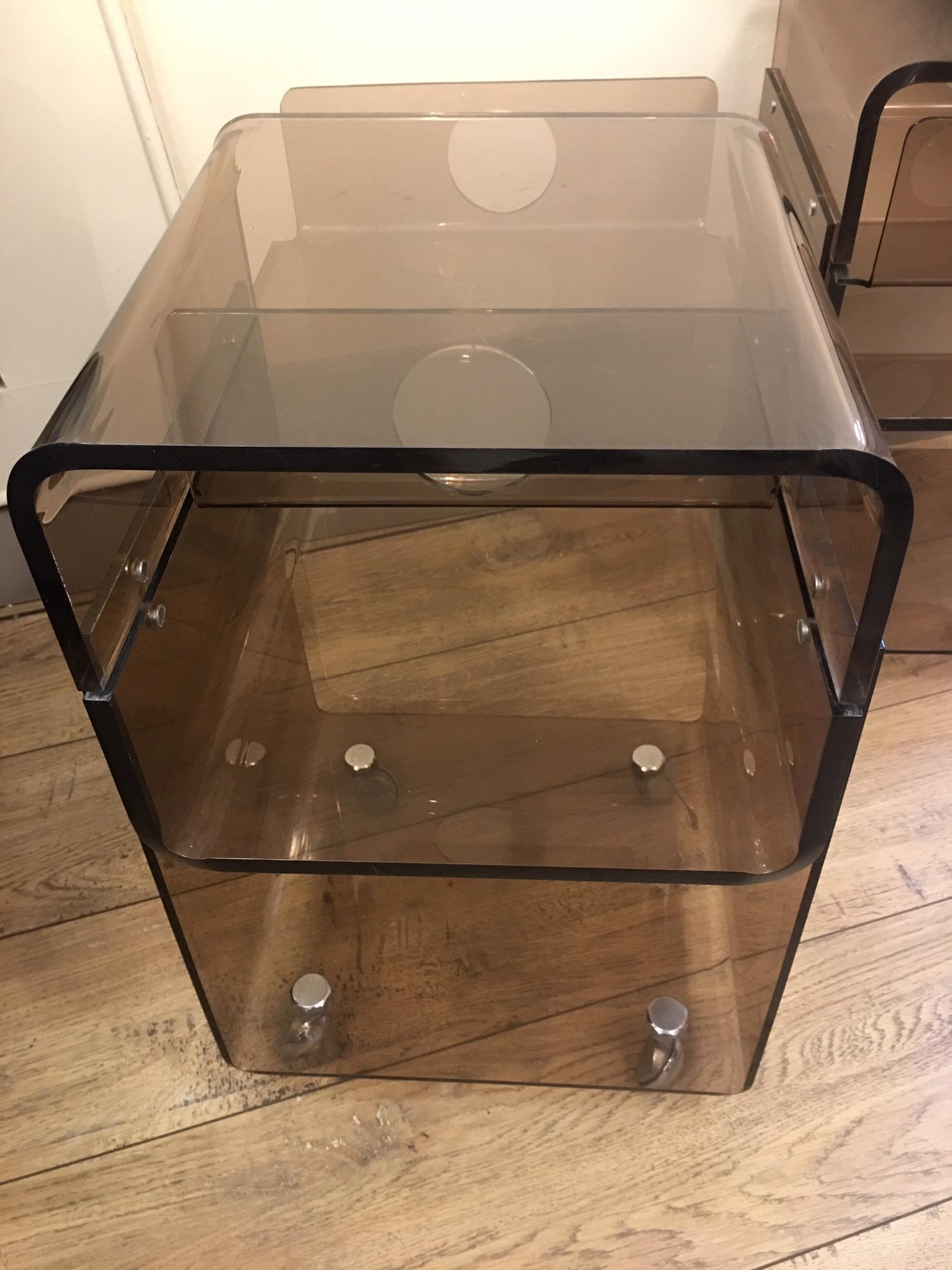 Pair of smoked-colored plexiglass bedside tables, 1970, with a drawer, for two nightstands.