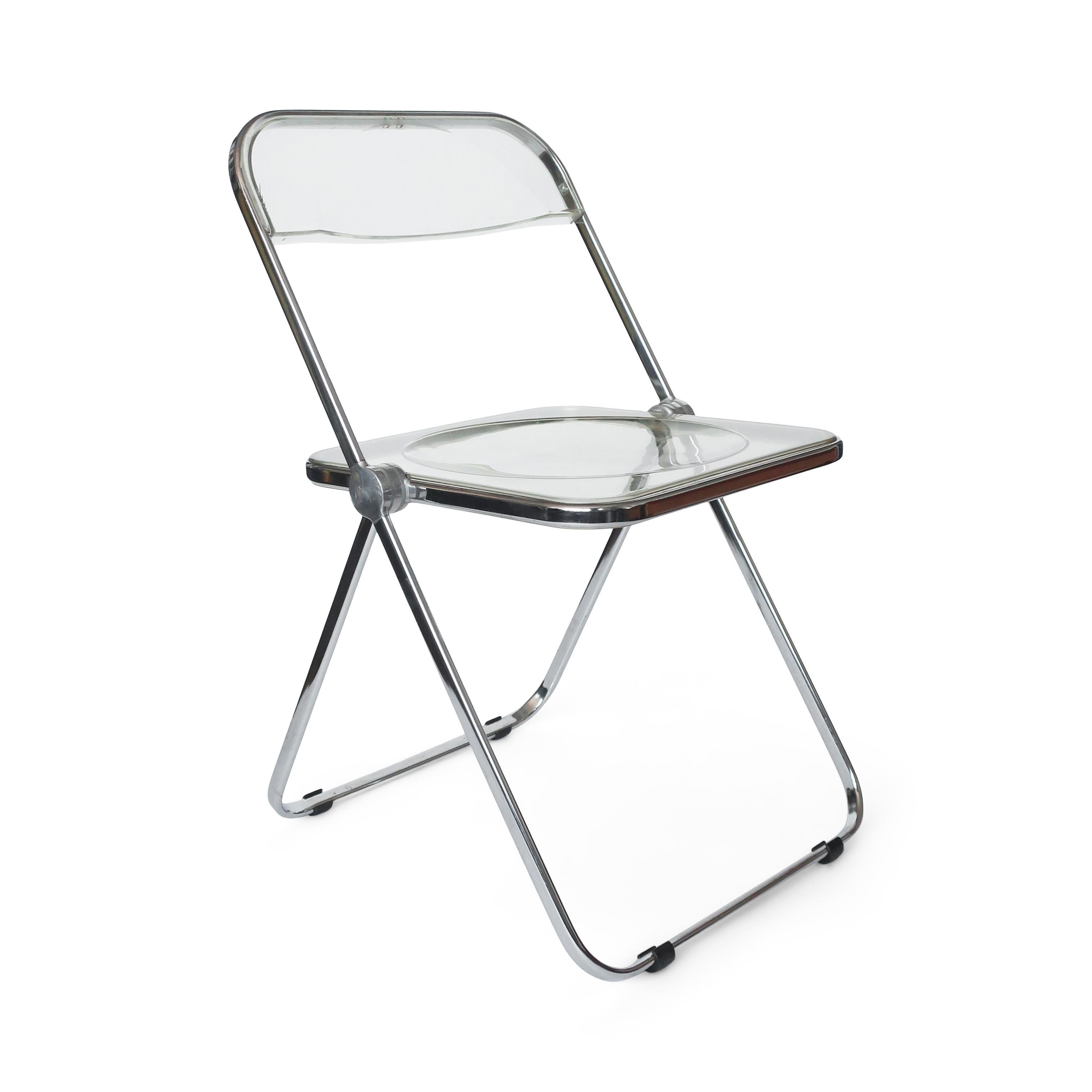 A pair of iconic Plia lucite and chrome folding chairs designed by Giancarlo Piretti for Castelli. Clear acrylic seats and back and a folding chrome frame.

In good vintage condition with wear consistent with age and use. Maker’s mark on chair’s