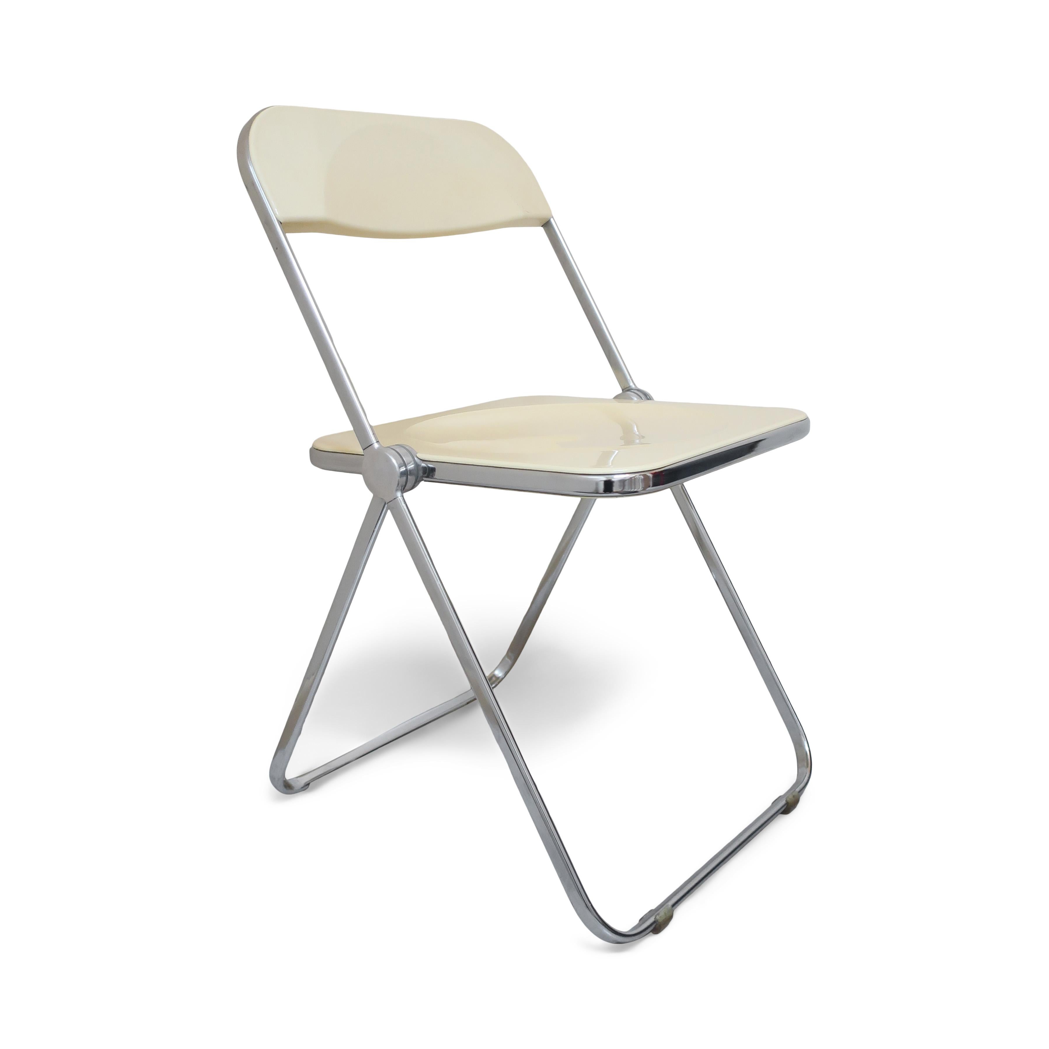 A pair of iconic Plia lucite and chrome folding chairs designed by Giancarlo Piretti for Castelli. Off-white seats and back and a folding chrome frame.

In good vintage condition with wear consistent with age and use. Plia sticker on underside of