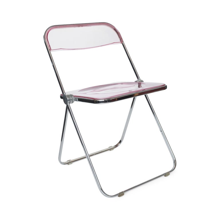A pair of iconic Plia lucite and chrome folding chairs designed by Giancarlo Piretti for Castelli. Rose-y pink acrylic seats and back and a folding chrome frame.

In good vintage condition with wear consistent with age and use. Maker’s mark on