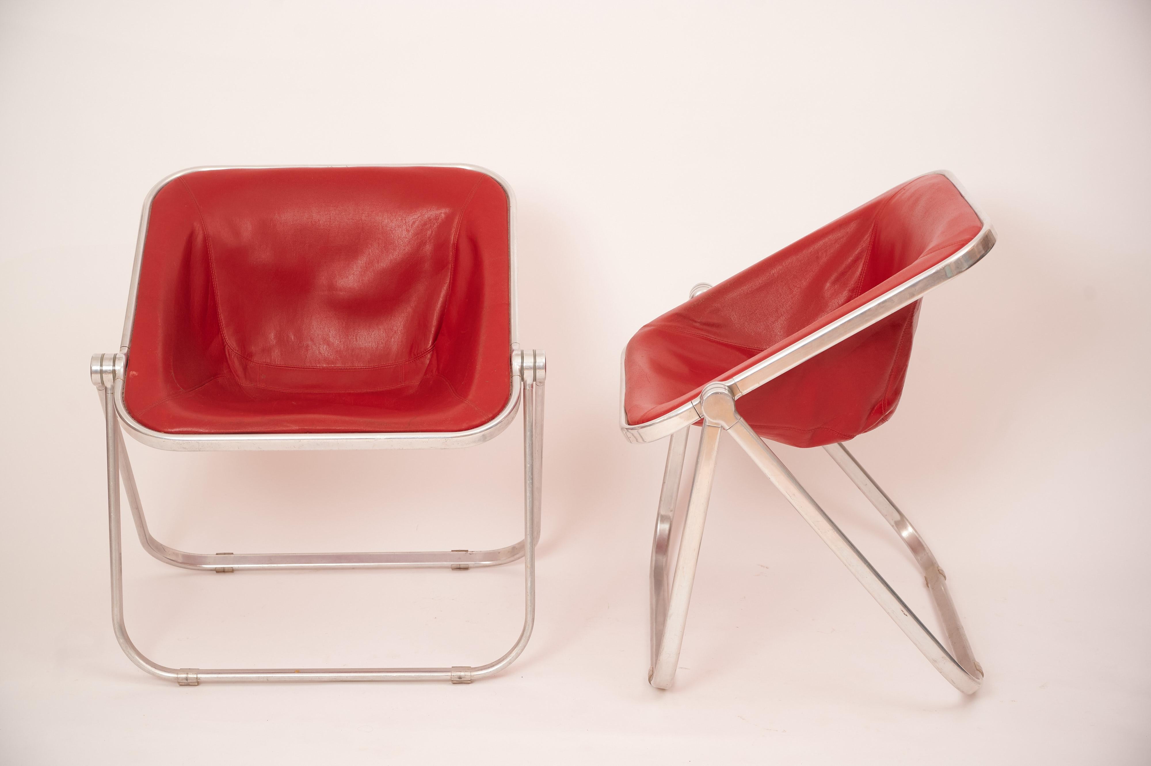 A pair of 'Plona' chairs by Giancarlo Piretti.

In a rare red leather. 

In excellent vintage condition. 

Minimal wear to leather. 

