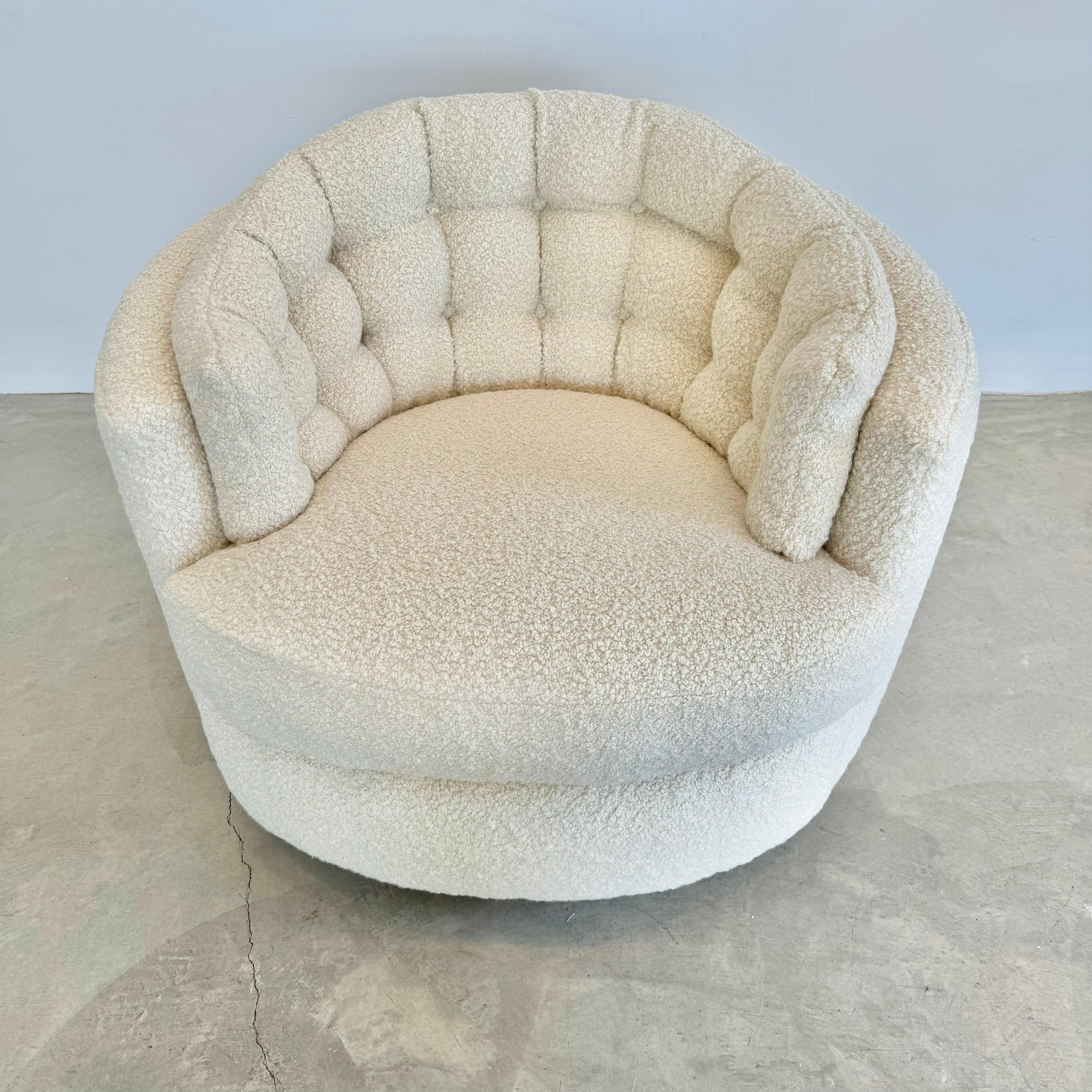 Stunning pair of swivel club chairs in a brand new plush Alpaca/wool boucle fabric. Wood plinth bases on both chairs. Tufted back cushion on chairs adds a ton of comfort and style. Chairs swivel comfortably and smoothly. All cushions on the seats