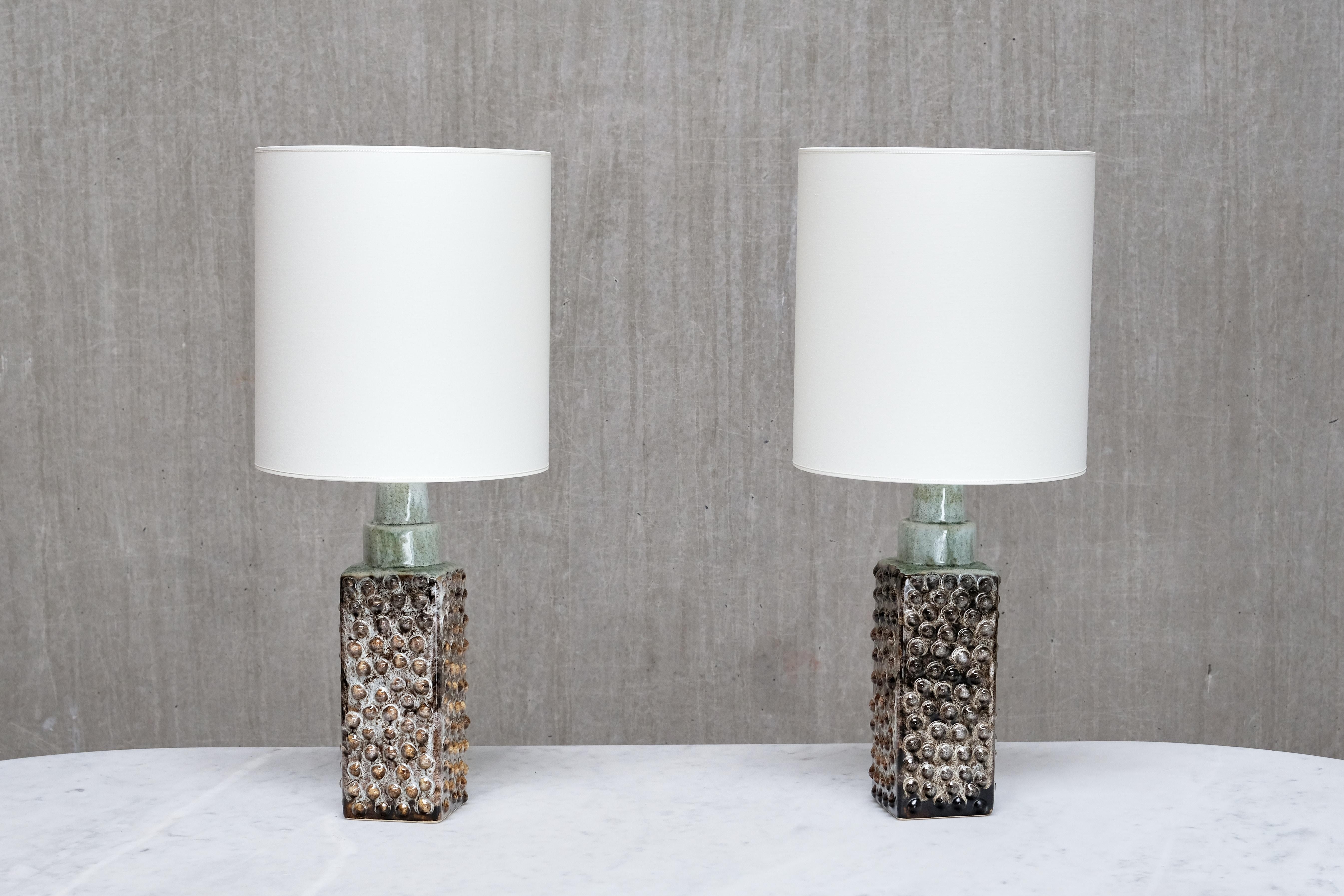 This striking pair of table lamps was produced by PM Keramik in Denmark in the 1960s. PM Keramik is believed to be a potter who has intentionally chosen to remain anonymous. Despite this, PM pieces are highly distinctive and recognizable, even