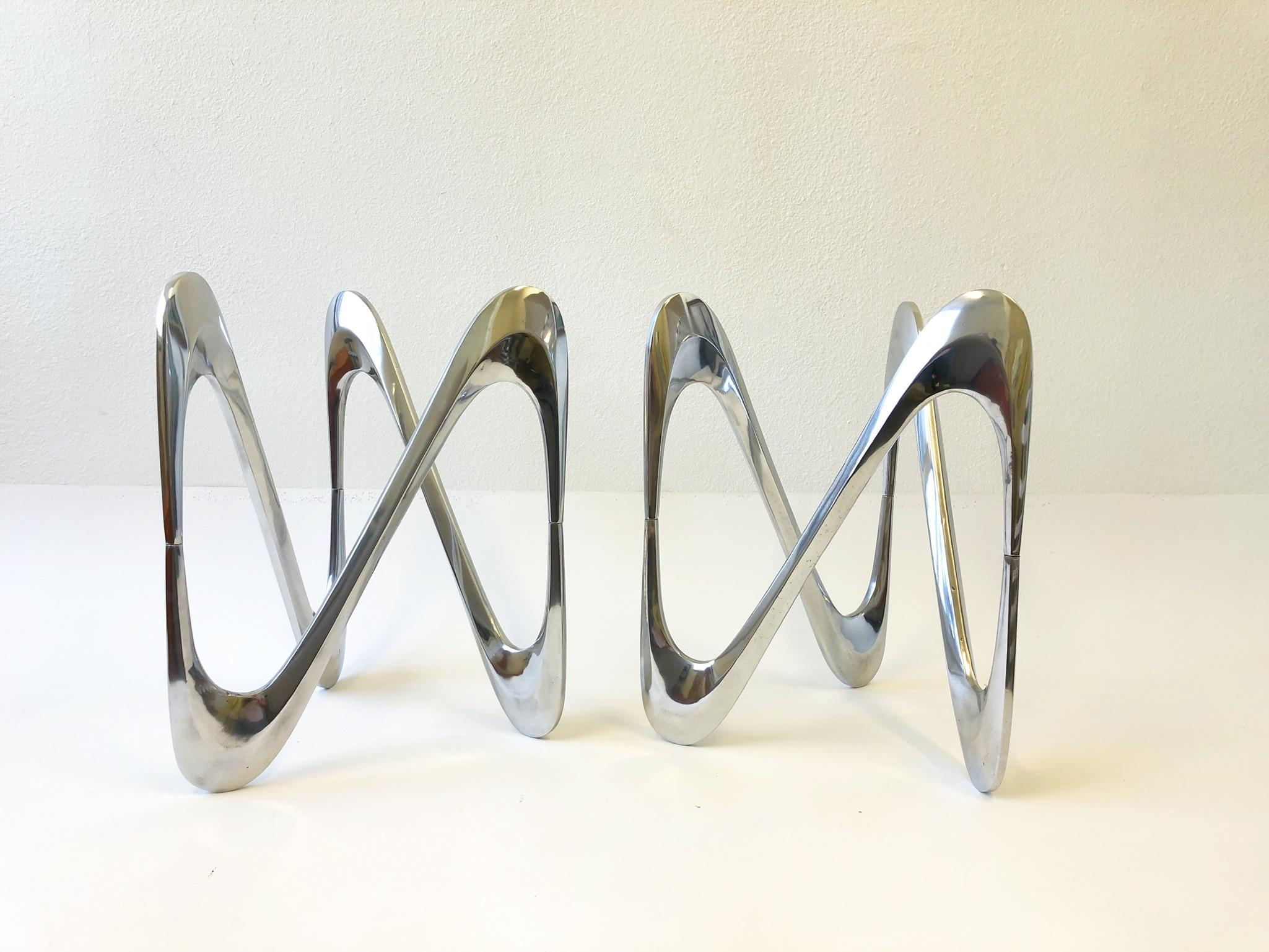 German 1970’s pair of polish aluminum “Snake” side tables by Knut Hesterberg.
Constructed of cast polish aluminum, they show minor wear consistent with age.
Can be used together to make a coffee table or separate as side tables.
Glass not