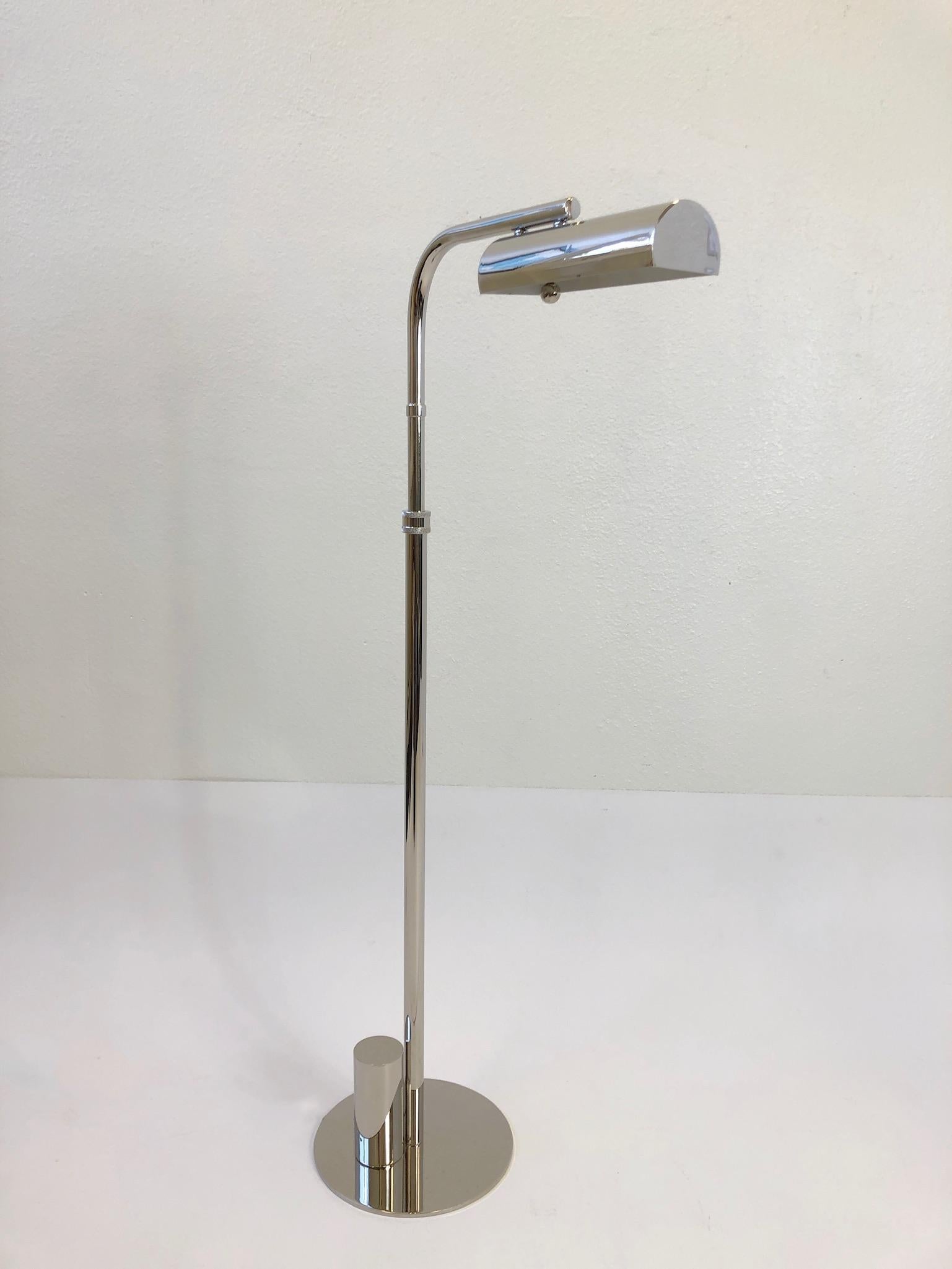 A glamorous pair of polish nickel “Ball Line” floor lamps design in the 1970s by Charles Hollis Jones. The lamps are signed by CHJ. The lamps have been newly replated and rewired with a full range dimmer. The lamps are adjustable they rotate 360*