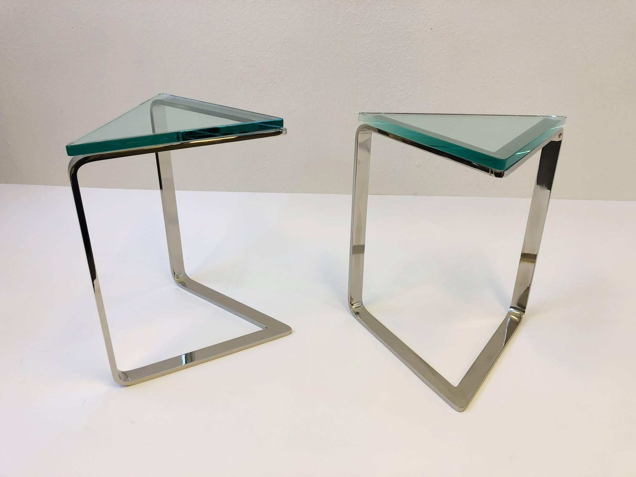 A spectacular pair of occasional tables that are triangular shape. The tables are constructed of solid steel and a 3/4” thick glass top.
The tables have been newly professionally polished and new glass tops.
Dimensions: 20.75” high, 18” wide and