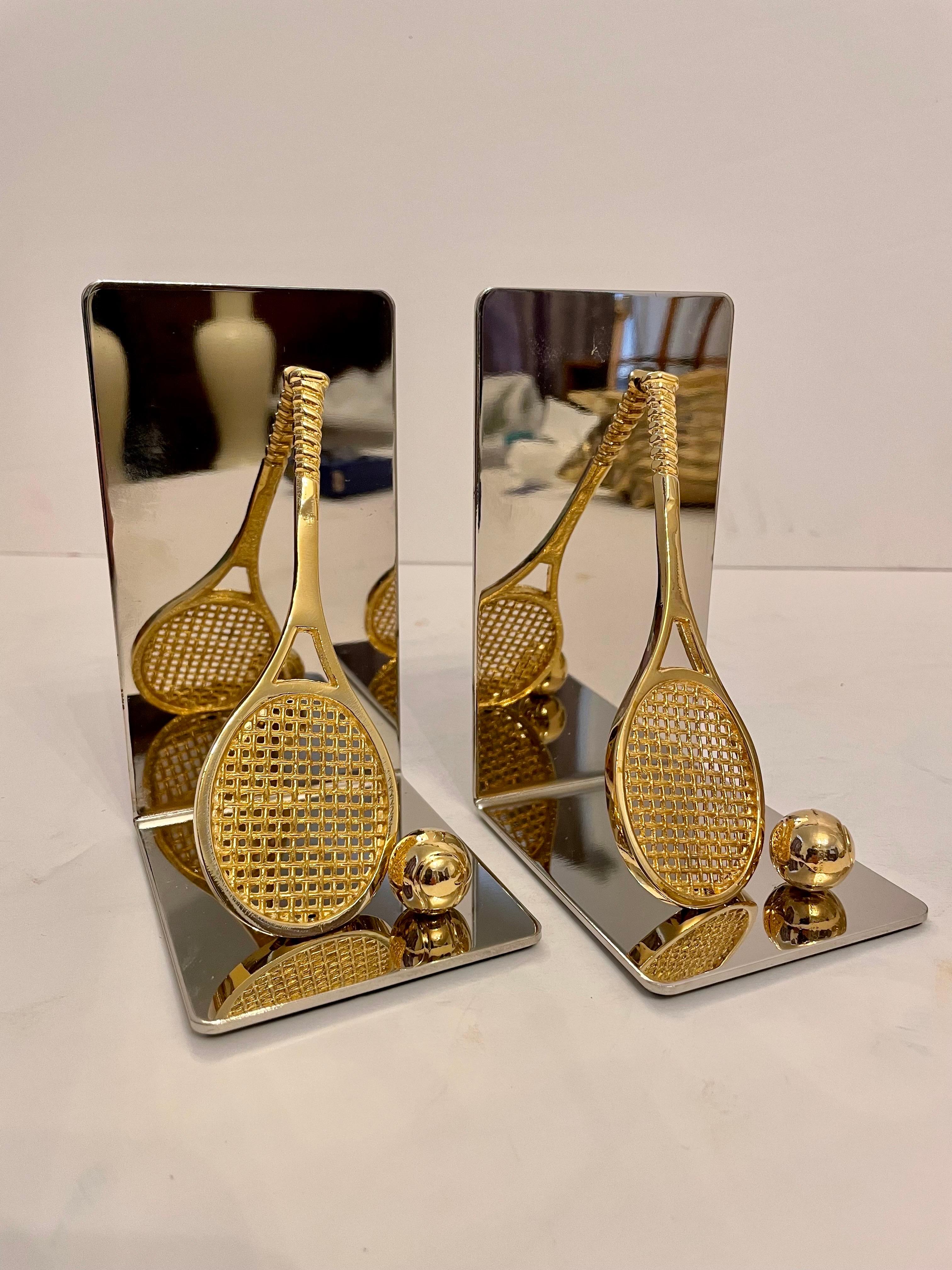 Nice set of brass and chrome tennis racket bookends. Features a brass tennis racket and ball on each. Has thin foam on bottom of each to prevent scratching furniture. 5.5