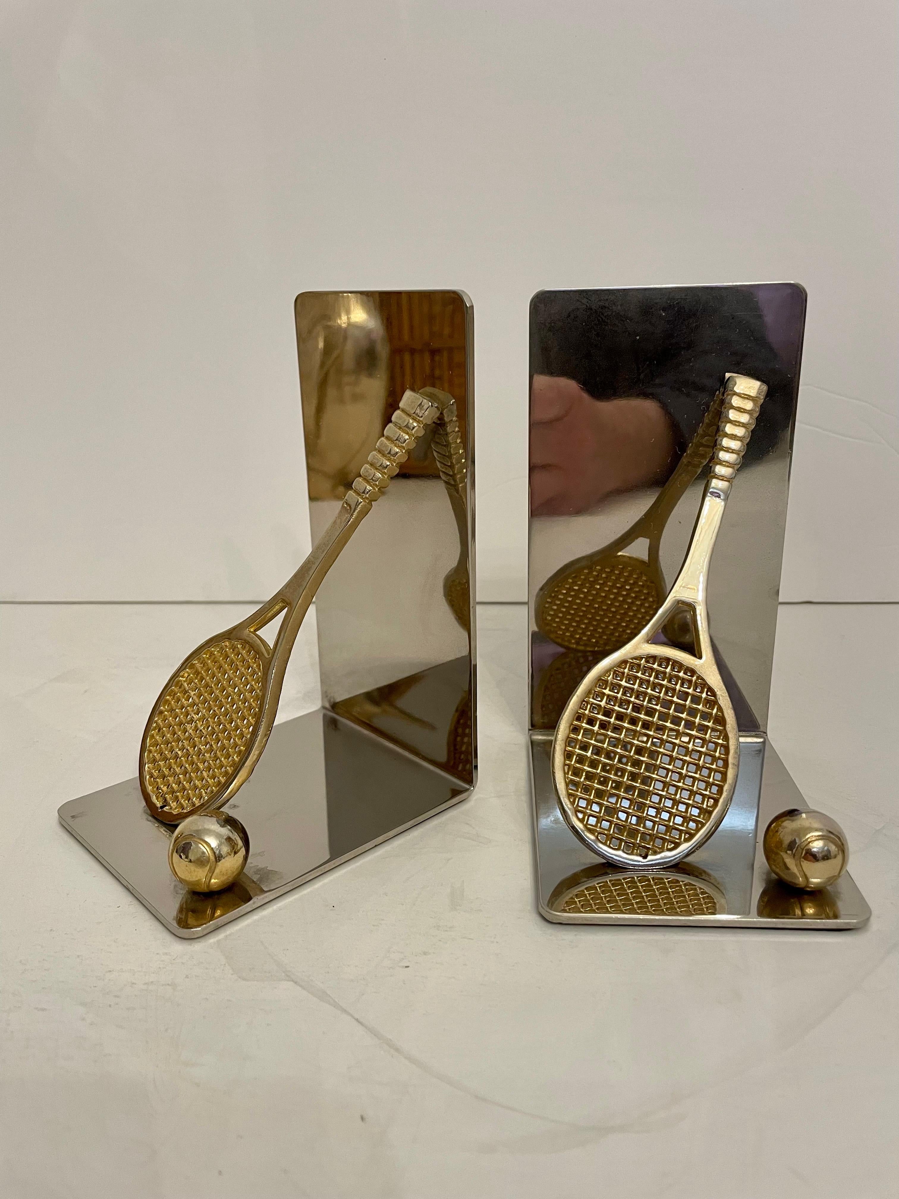 Nice set of brass and chrome tennis racket bookends. Features a brass tennis racket and ball on each. Has thin foam on bottom of each to prevent scratching furniture. 5.5