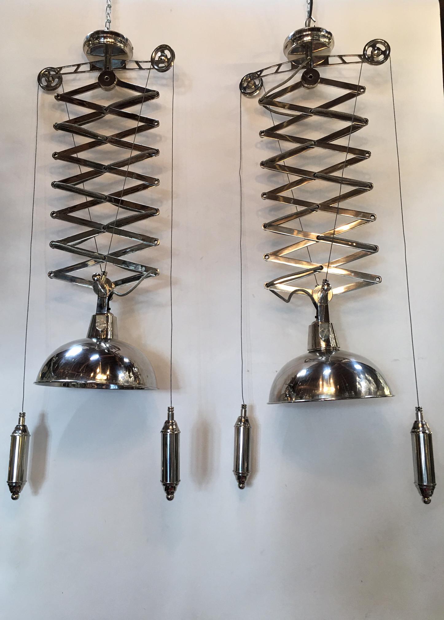 Two polished chrome accordion pendant chandeliers. The pendants can extend to be 67 inches long.