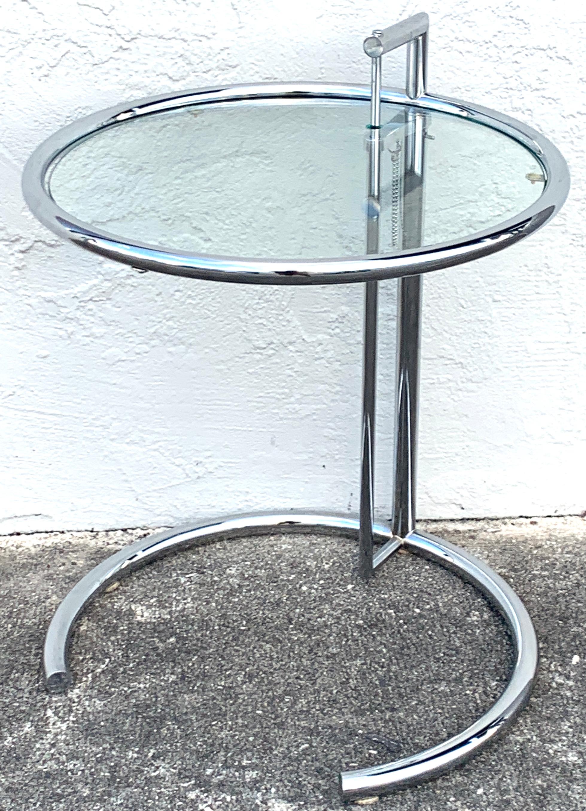 Pair of polished chrome and glass E-1027 side tables, in the style of  Eileen Gray
each one fine vintage models, with no chips, or missing pieces, fresh from a Palm Beach estate.
         
