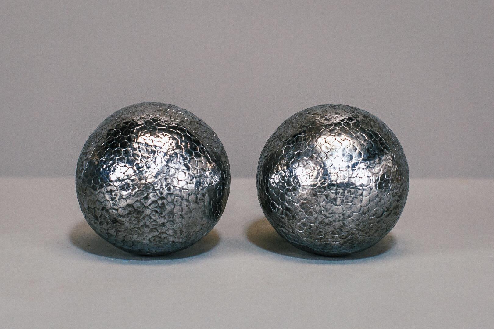Pair of early 19th century Boules de lyonnaise or petanque boules, hammered nails into wooden ball, with decorative design using iron and brass nails to help differentiate each players boules. Highly polished.
 