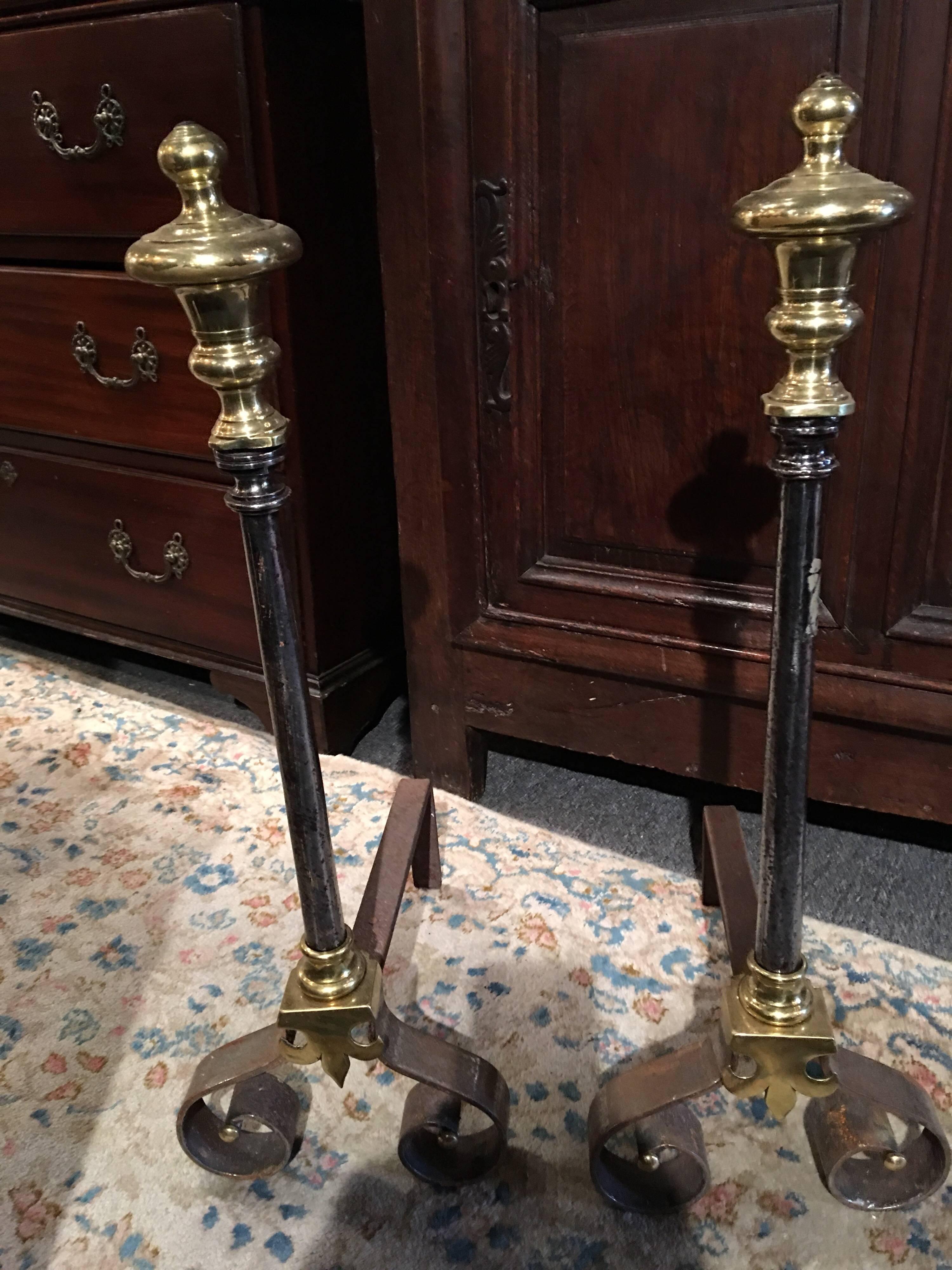 Pair of polished iron and brass chenets or andirons, 19th century.